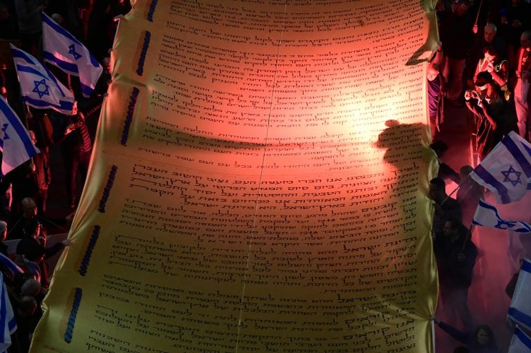 Demonstrators wave a giant model of the Declaration of Independence, in Tel Aviv