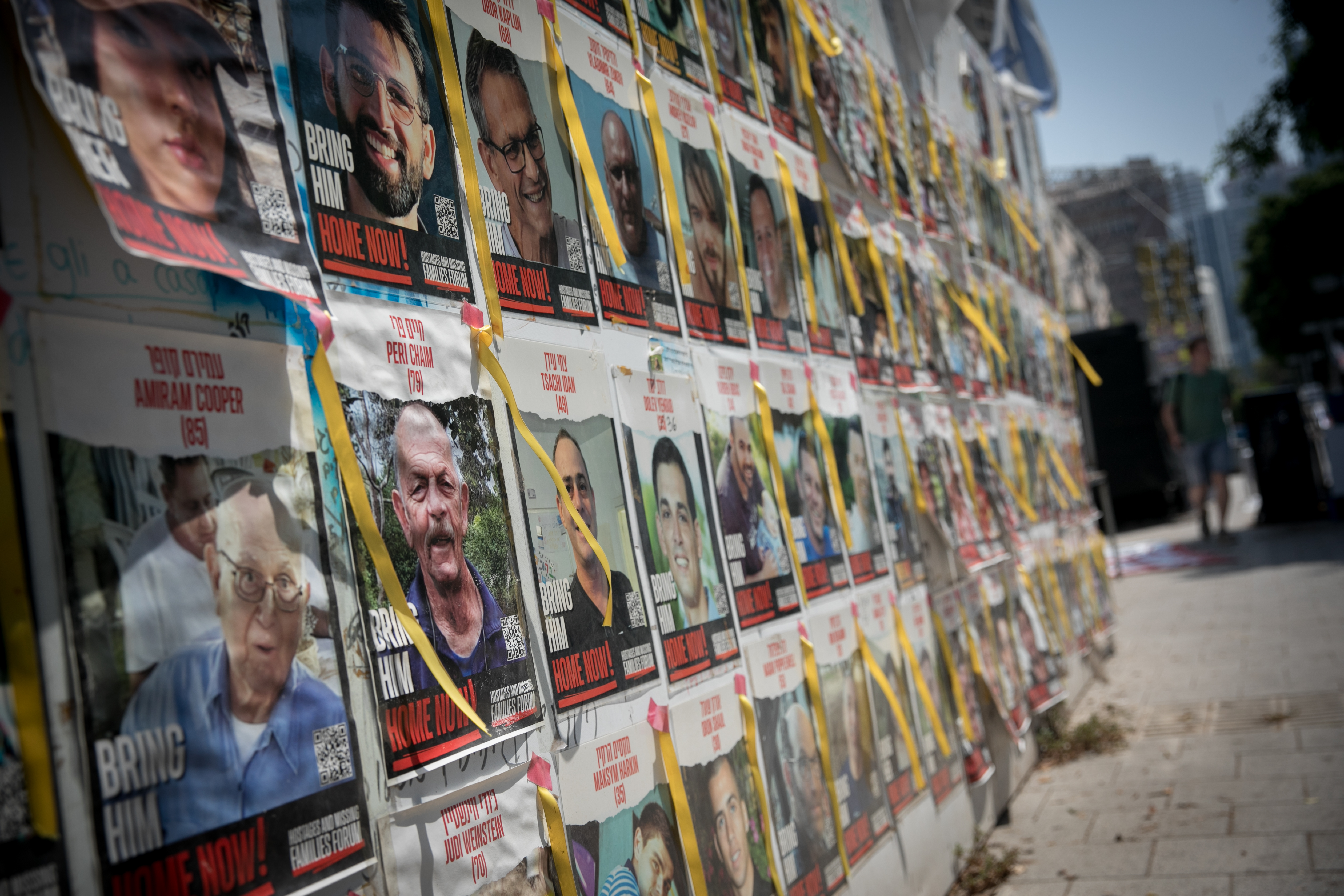 Wall of posters showing those still held in Gaza.