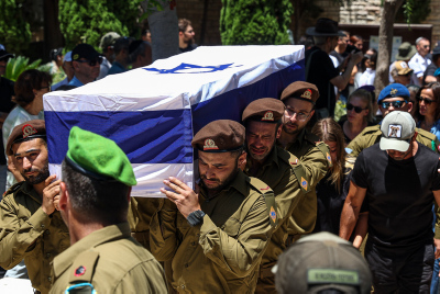 Family and friends of Israeli soldier Sergeant first class (res.) Omer Smadga attend his funeral at the military cemetery in Netanya on June 21, 2024. He was killed in combat in the Gaza Strip.