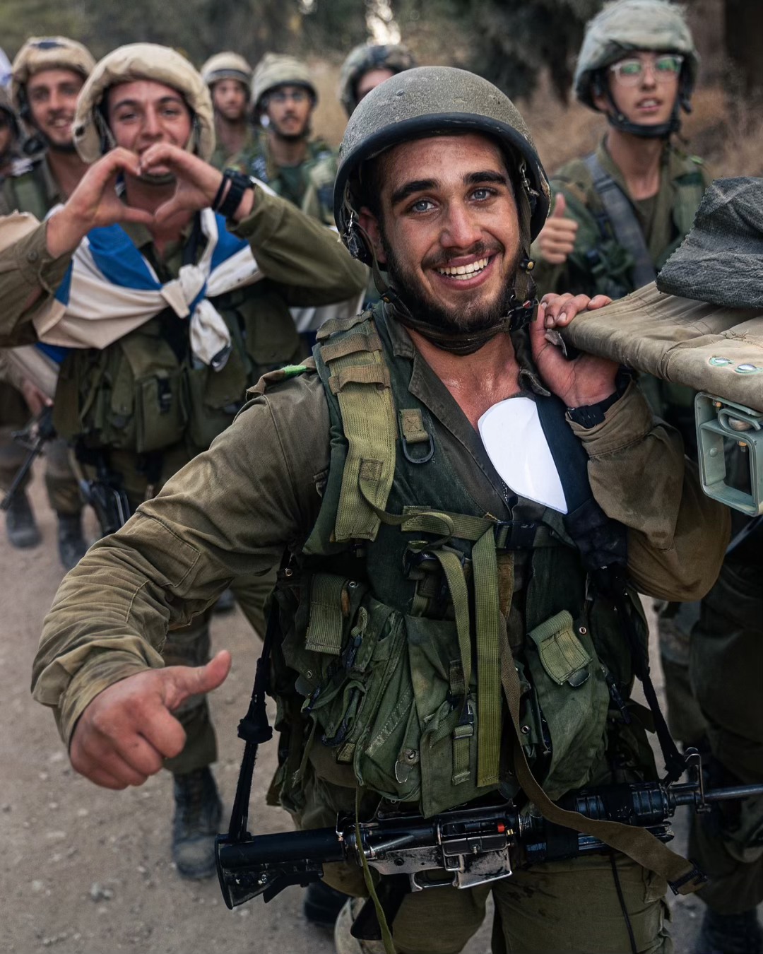 IDF recruit is still smiling while carruing a weighted backpack AND a stretcher