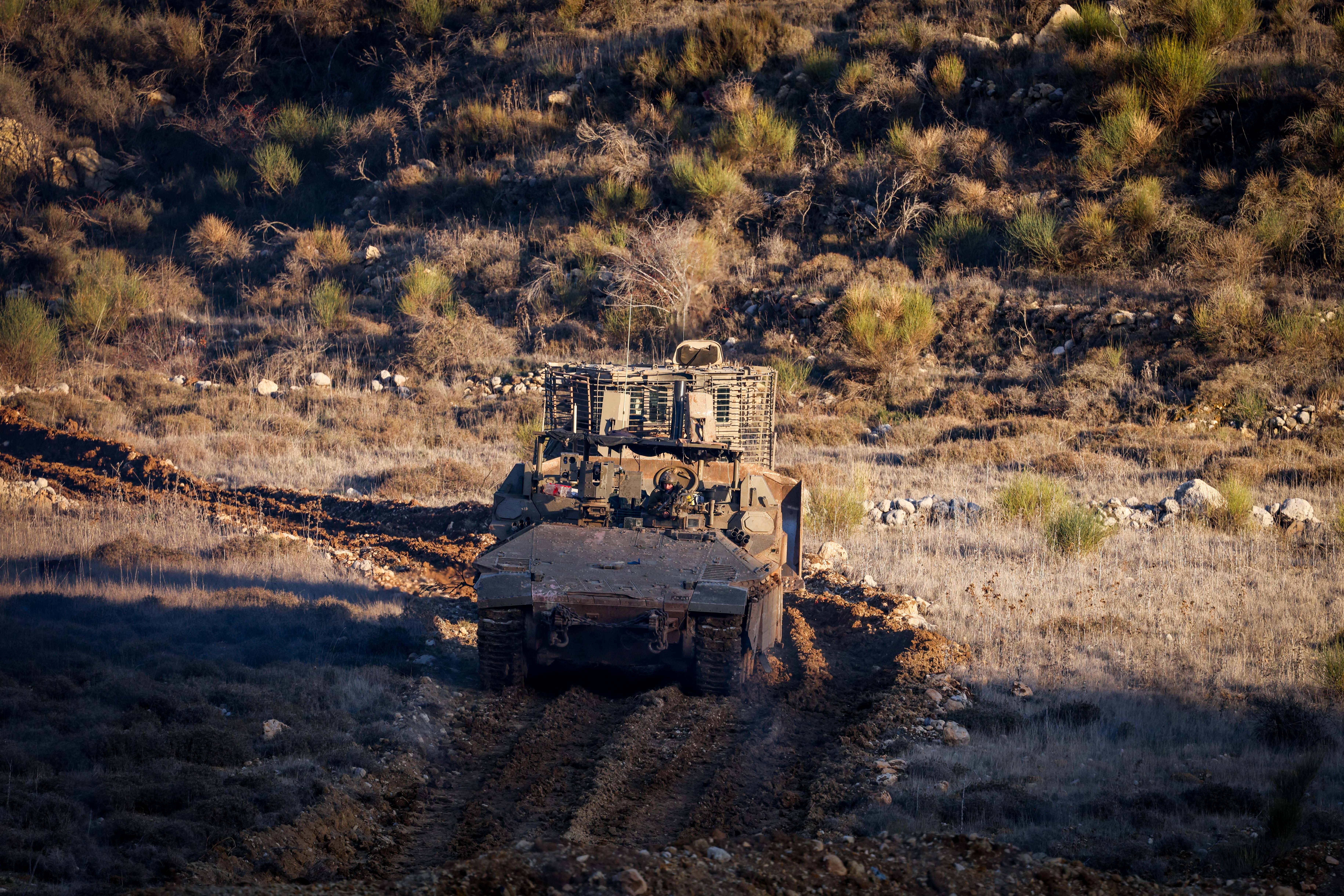 Israeli soldiers operating in the Syrian side of the border fence with Israel, northern Israel, December 25, 2024. 