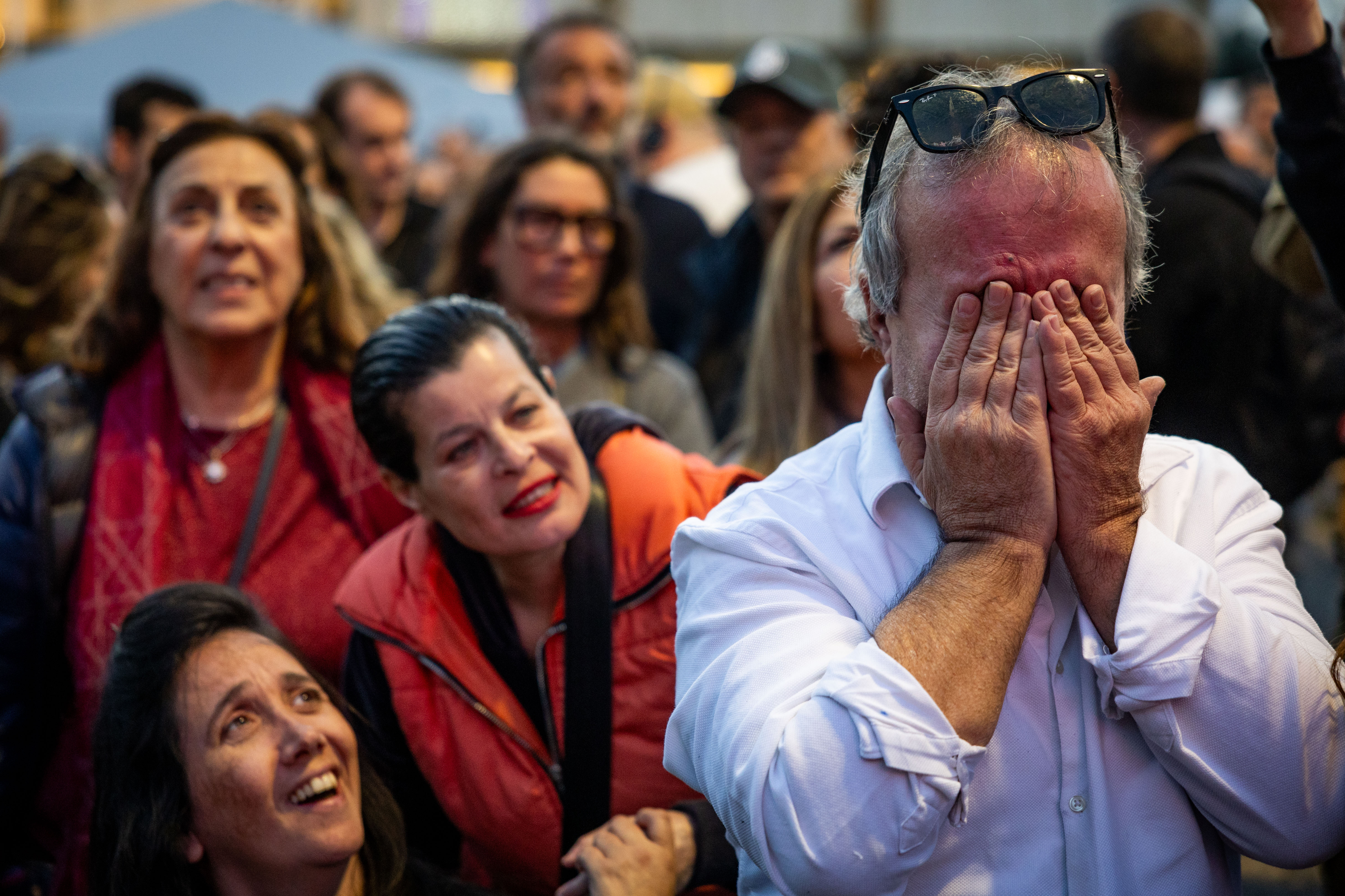 Israelis watch the release of three hostages from Hamas captivity as part of a deal between Israel and Hamas, at hostage square in Tel Aviv, January 19, 2025. 