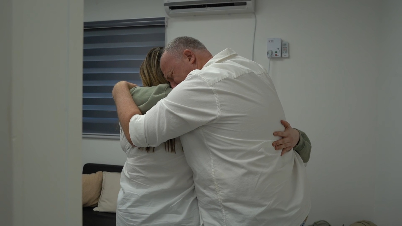 Agam Berger hugs her father