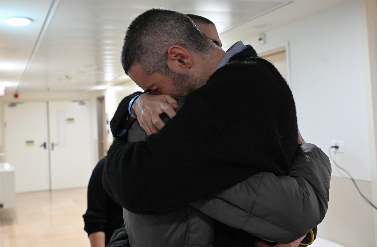 Or Levy in an emotional reunion with his family members upon his arrival at Sheba Hospital.