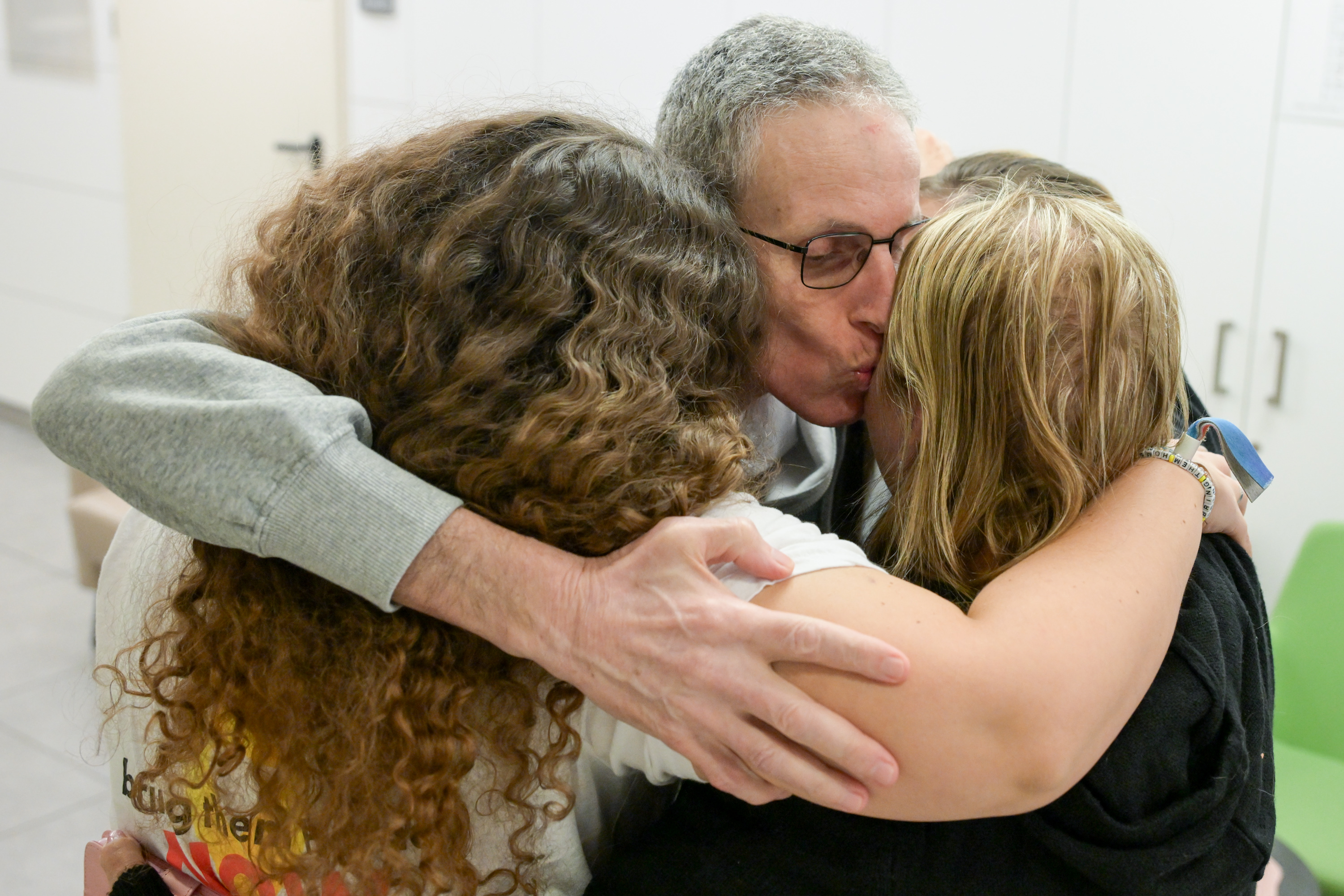 In color: Freed hostage Ohad Ben Ami reunites with his wife and daughters – and our hearts are so full