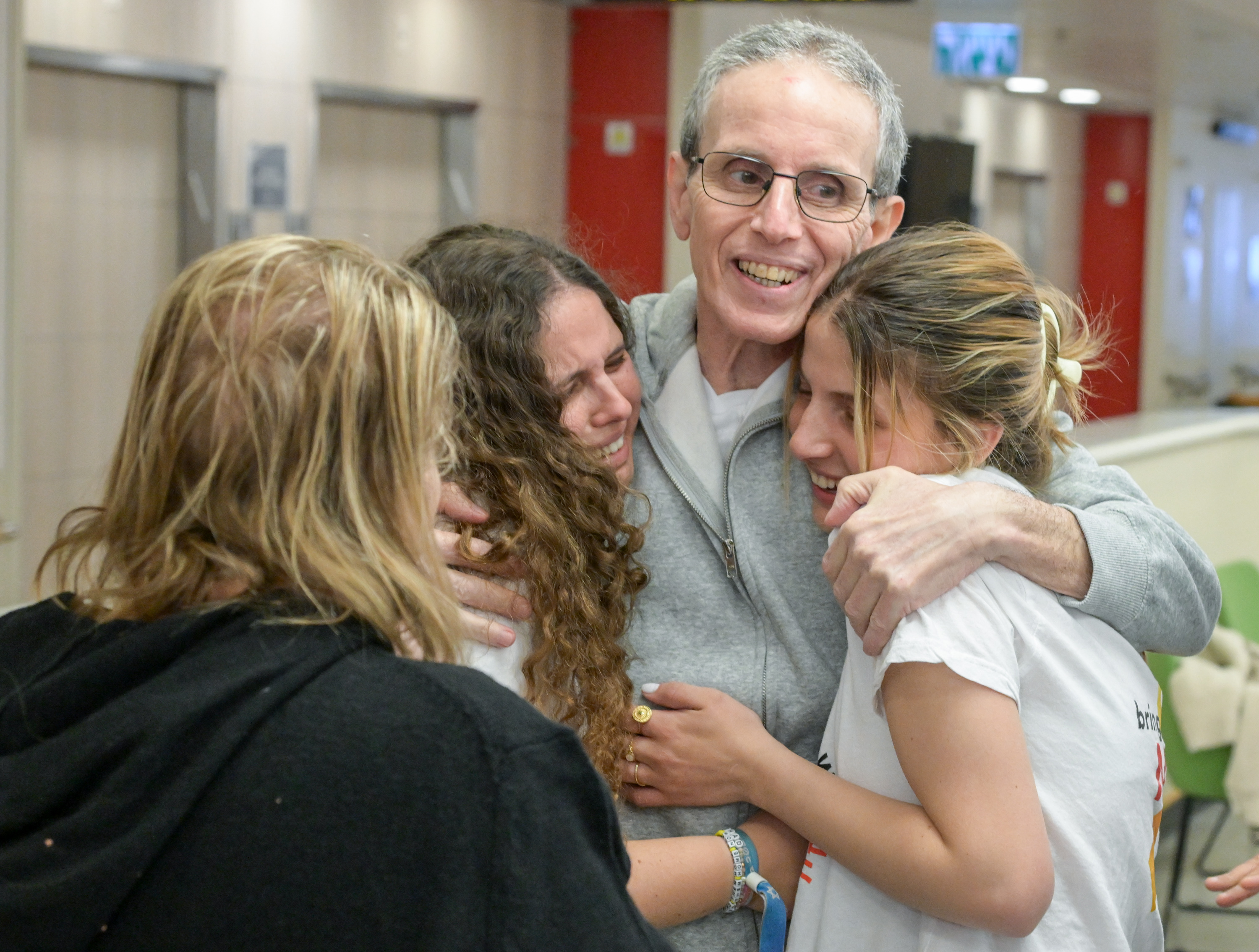 In color: Freed hostage Ohad Ben Ami reunites with his wife and daughters – and our hearts are so full