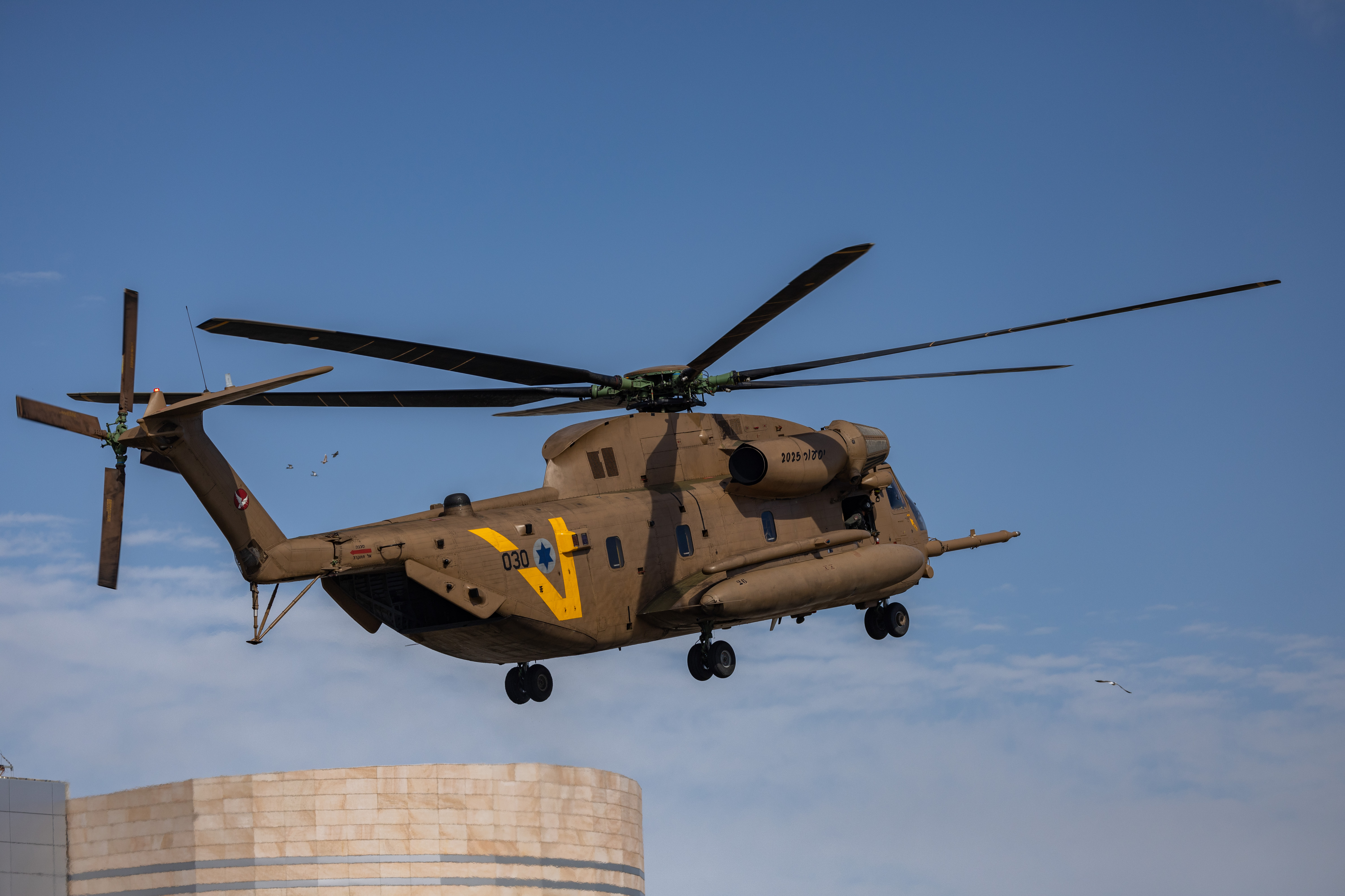 Military helicopter flying out hostages.