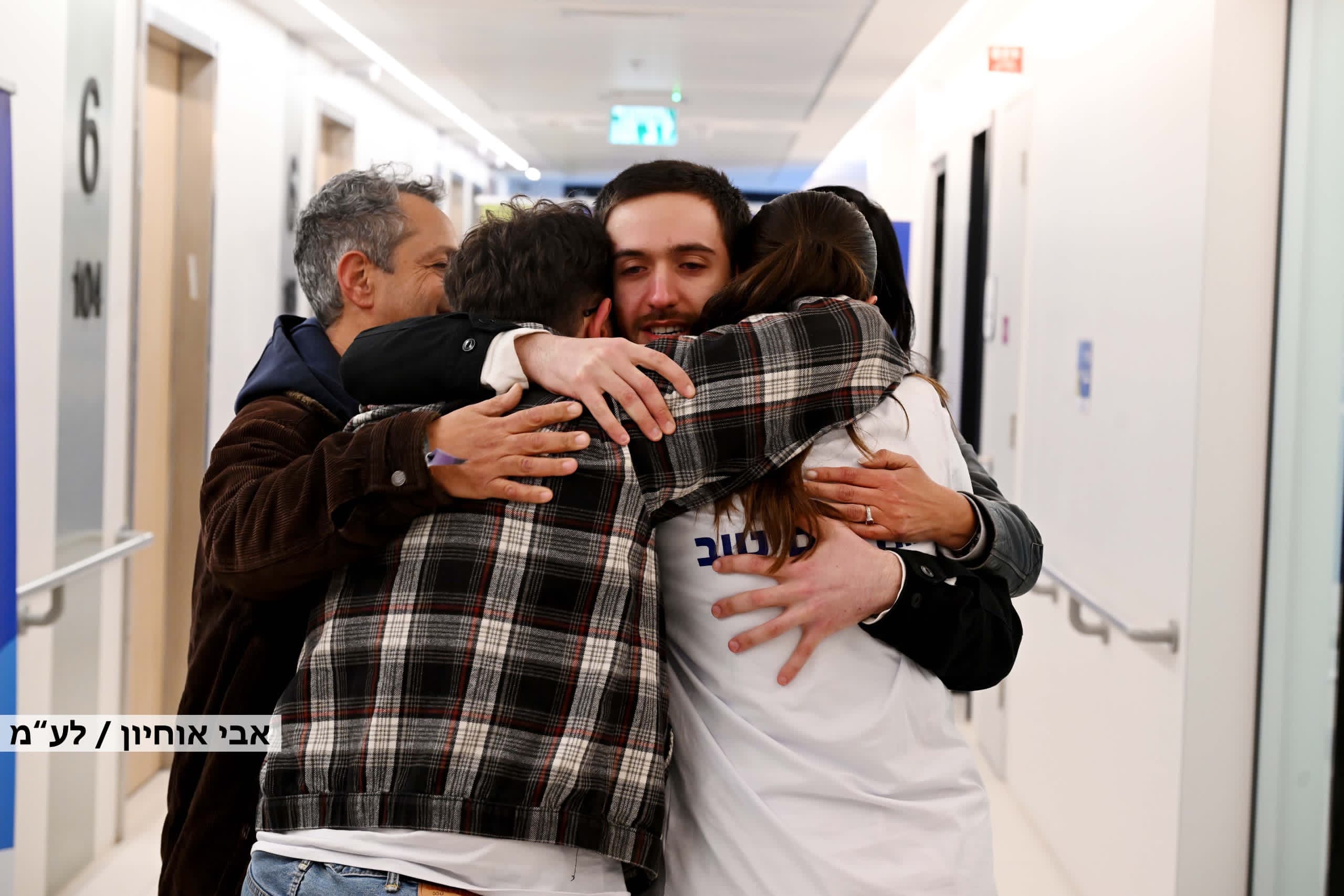 Omer Shem Tov hugs his family