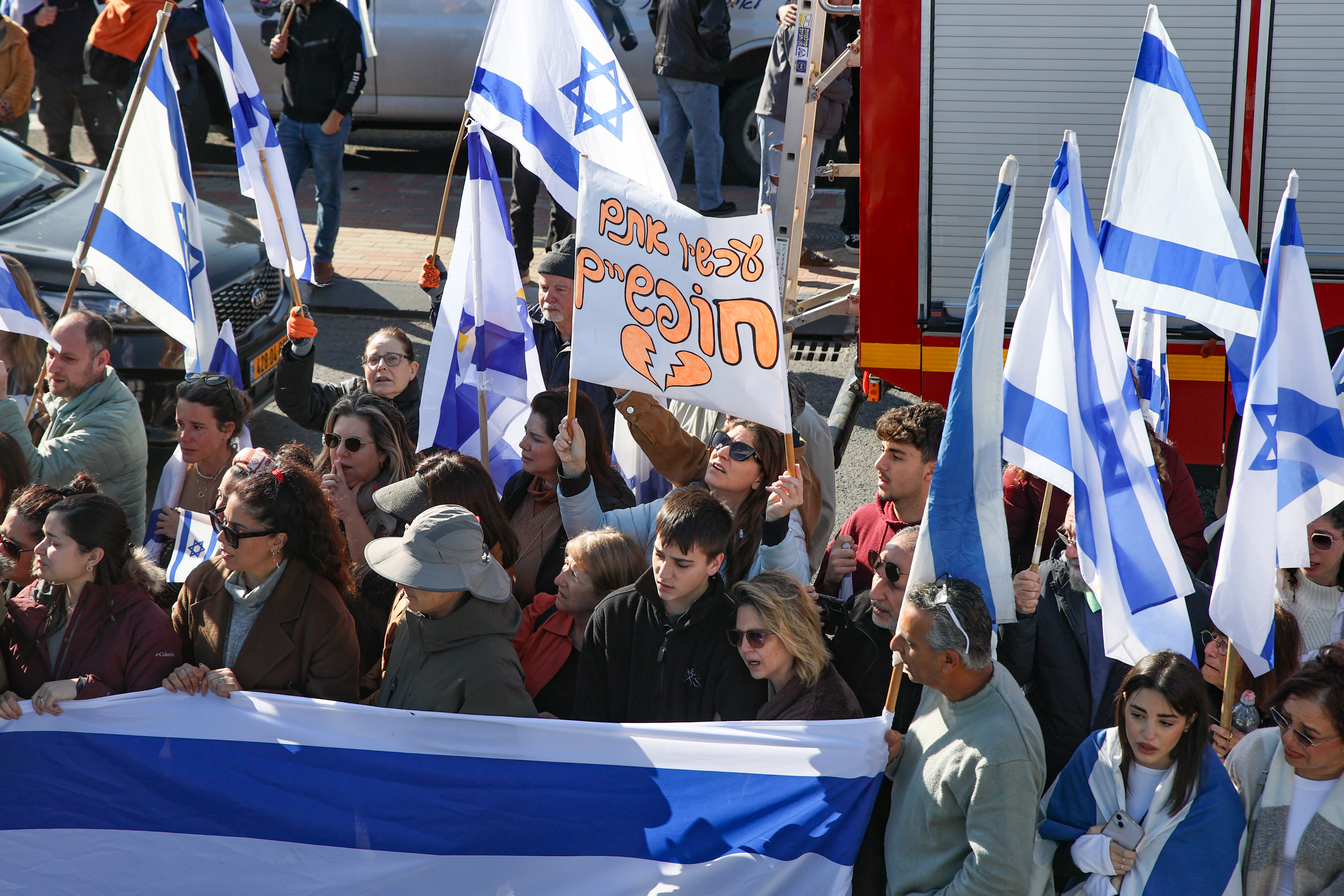 People pay their respects during the funeral service of late Israeli hostages Shiri Bibas and her children Ariel and Kfir in Rishon LeZion, February 26, 2025.
