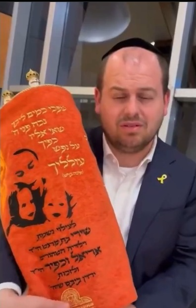 Shai Graucher and the Bibas memorial Torah scroll.