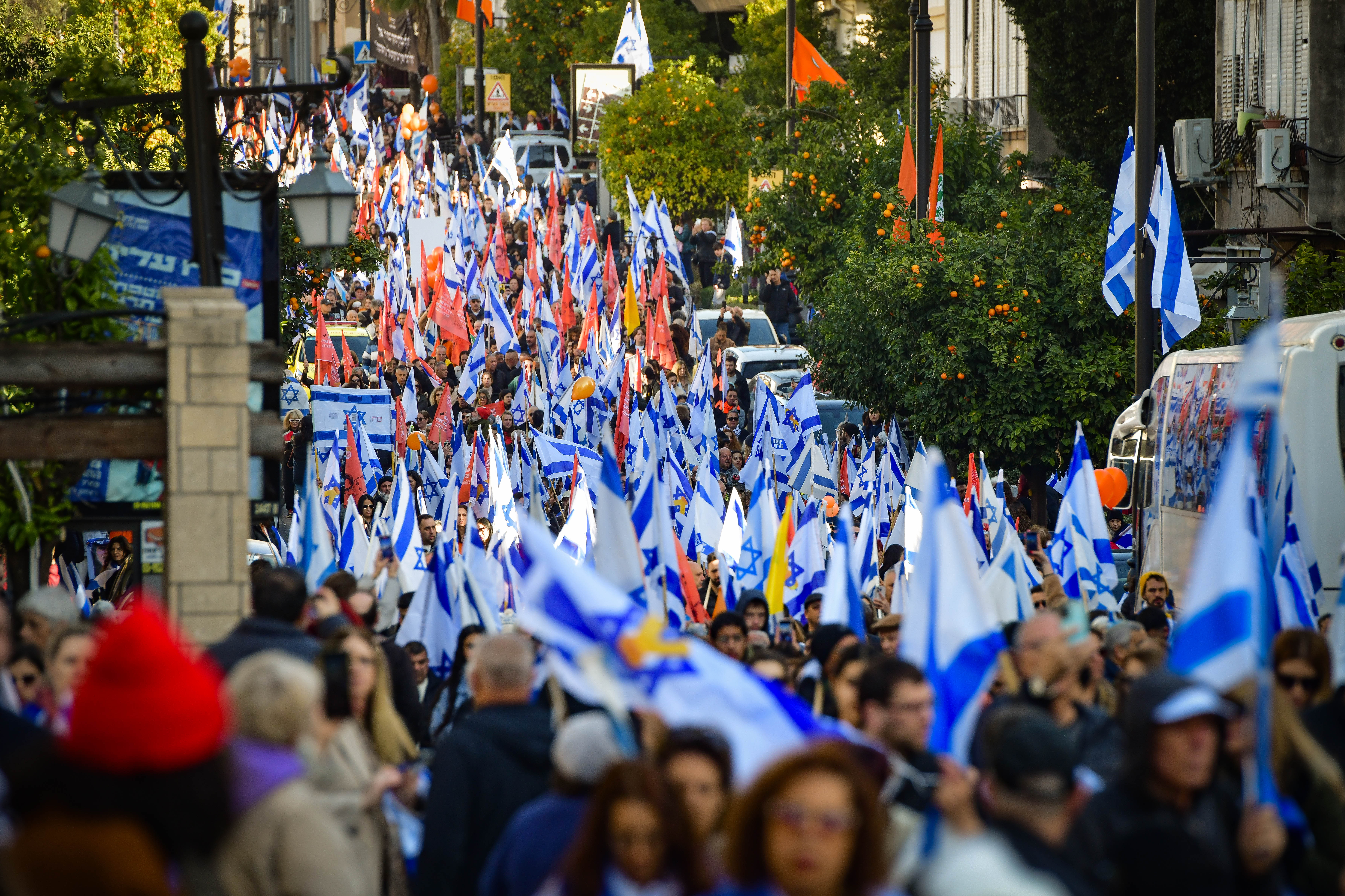 People pay their respects during the funeral service of late Israeli hostages Shiri Bibas and her children Ariel and Kfir in Rishon LeZion, February 26, 2025.