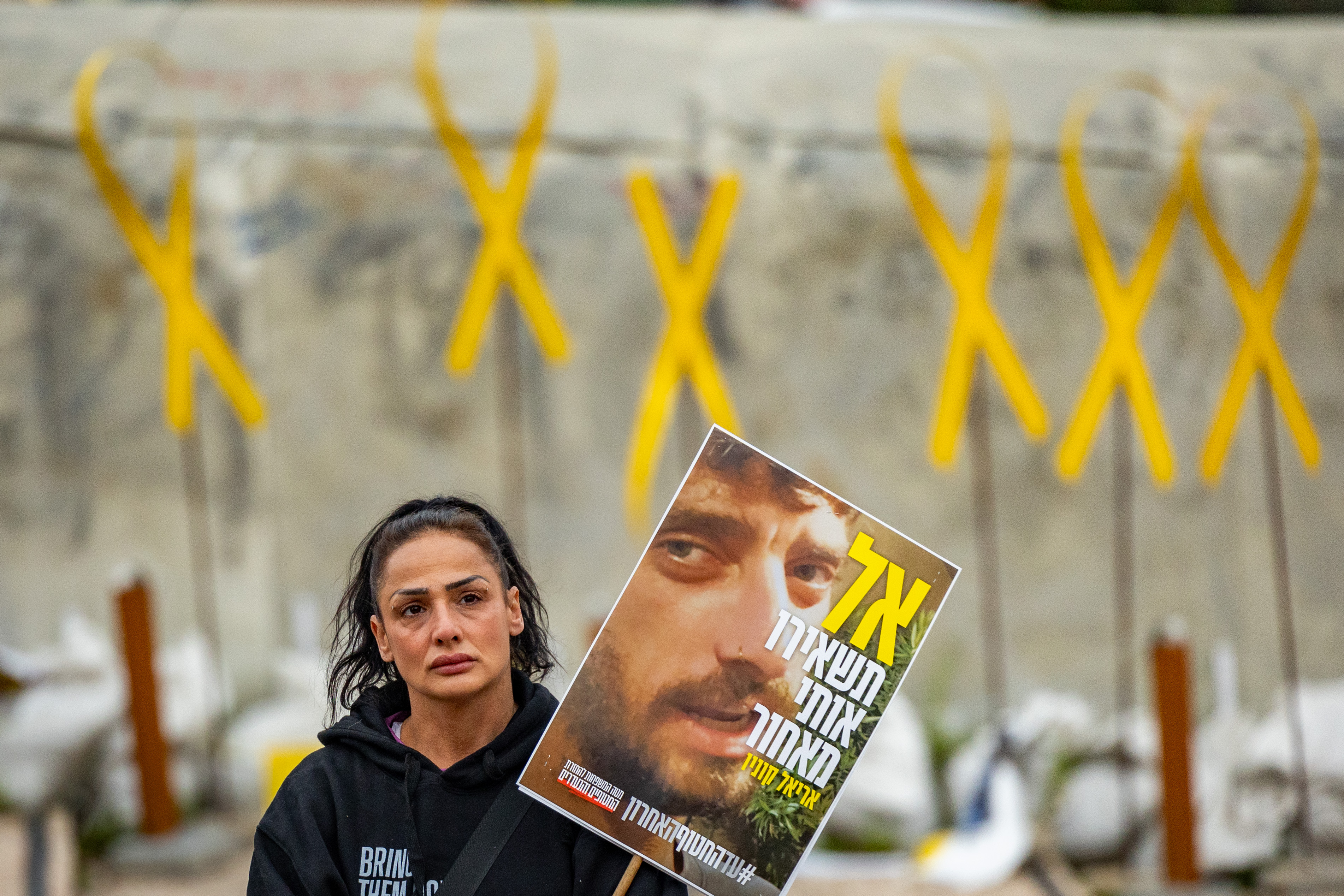Israelis watch the release of three hostages from Hamas captivity as part of a deal between Israel and Hamas, at Hostage square in Tel Aviv, February 22, 2025. 