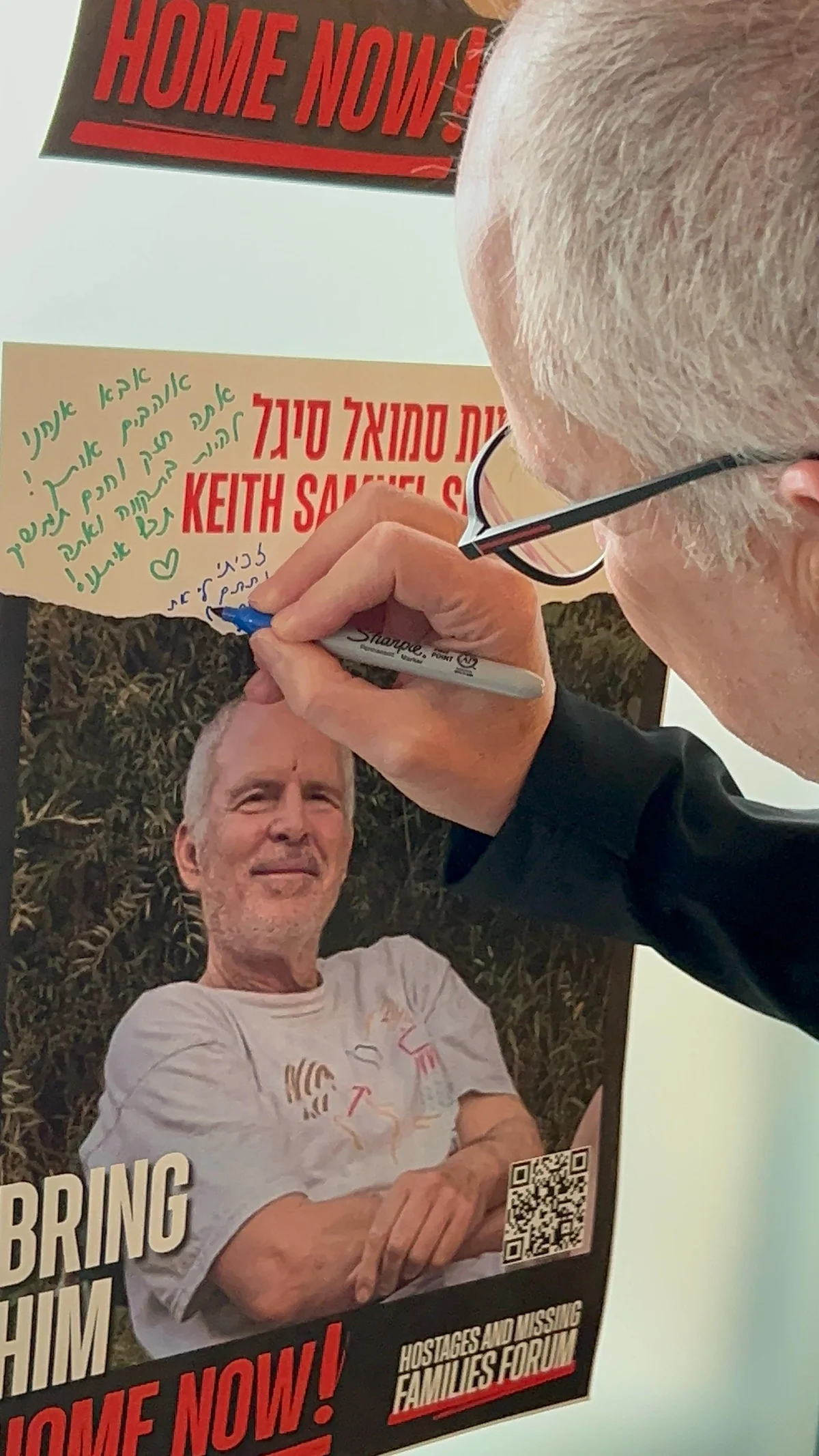 Keith Seigel writing on his hostage poster