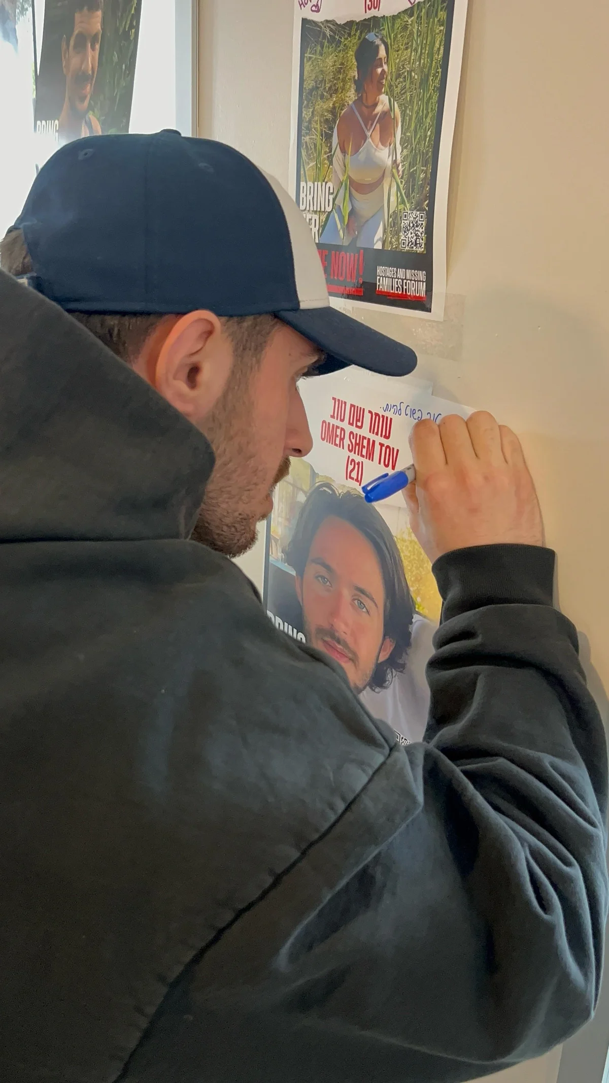 Omer Shem Tov writing on his hostage poster