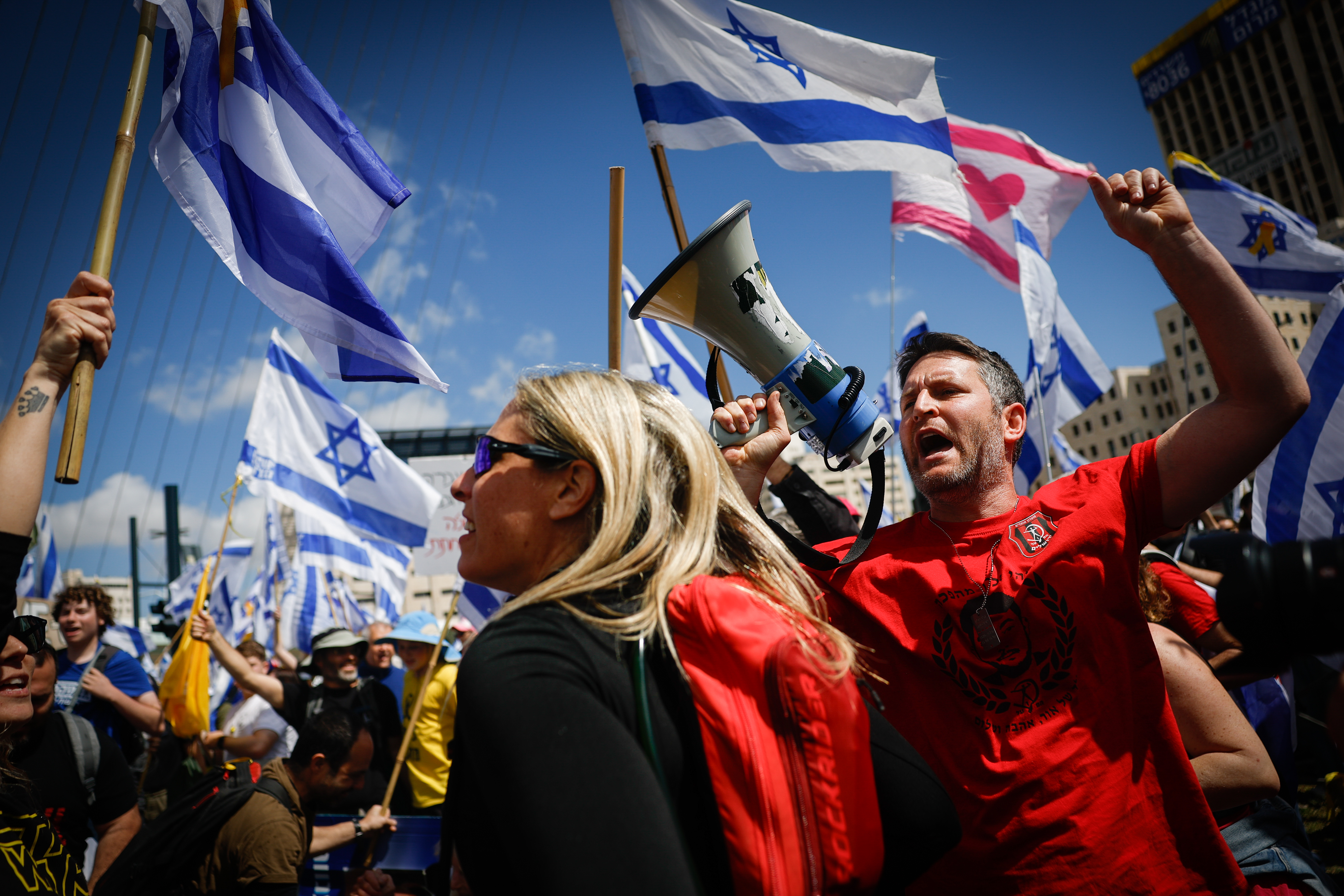 sraelis attend a protest march against the decision of Israeli prime minister Benjamin Netanyahu to fire head of Shin Bat Ronen Bar, at the entrance to Jerusalem, March 19, 2025. 