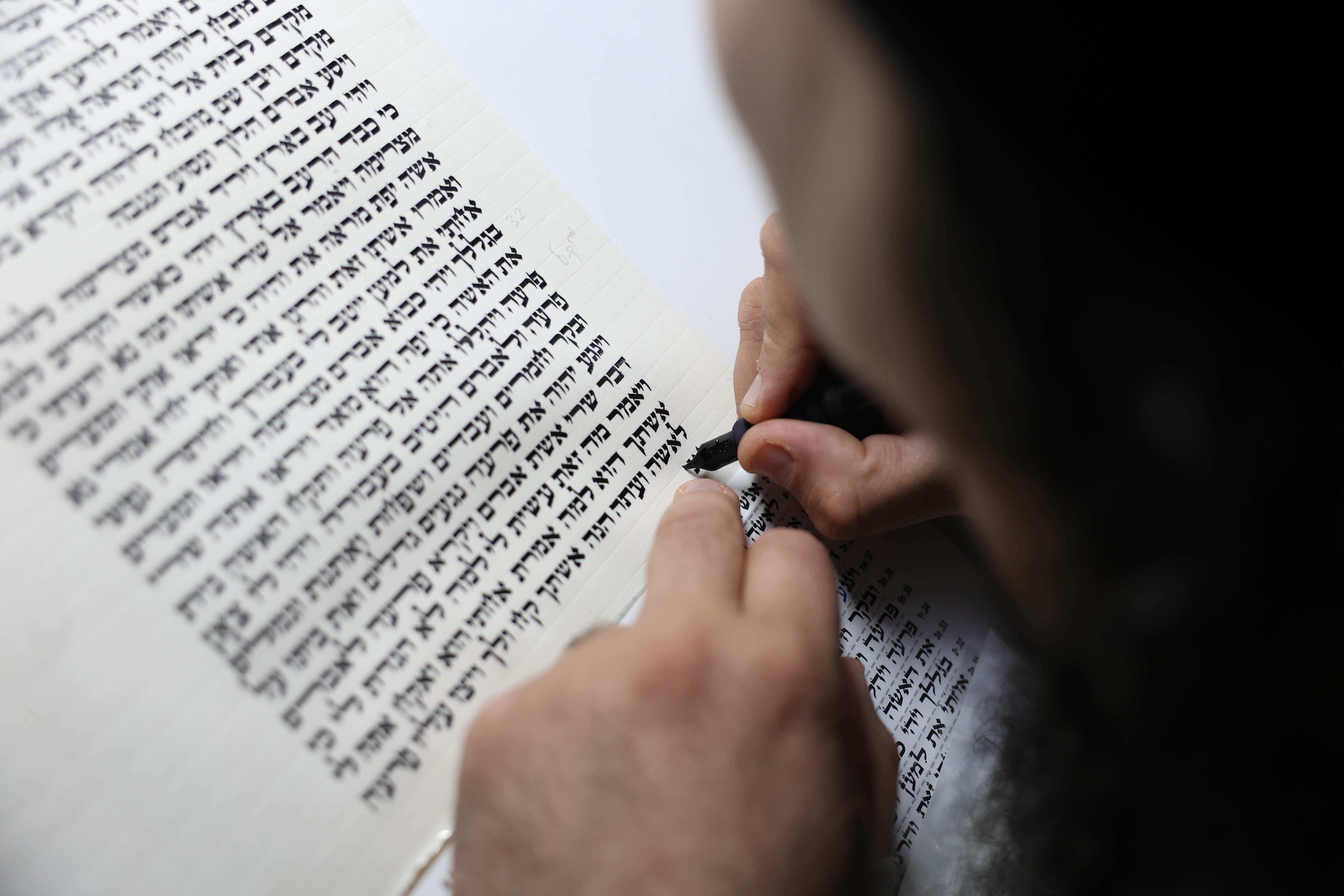 Nadav Elhadad, a Sefer Torah scribe, sofer stam, from the "Har Sinai" foundation, seen scribing a new Torah scroll in the Northern Israeli town of Tzfat. February 10, 2025. 