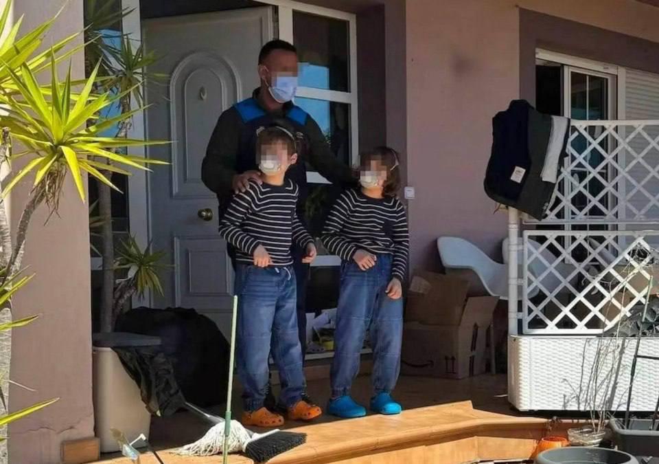 Father and 2 children emerging from home