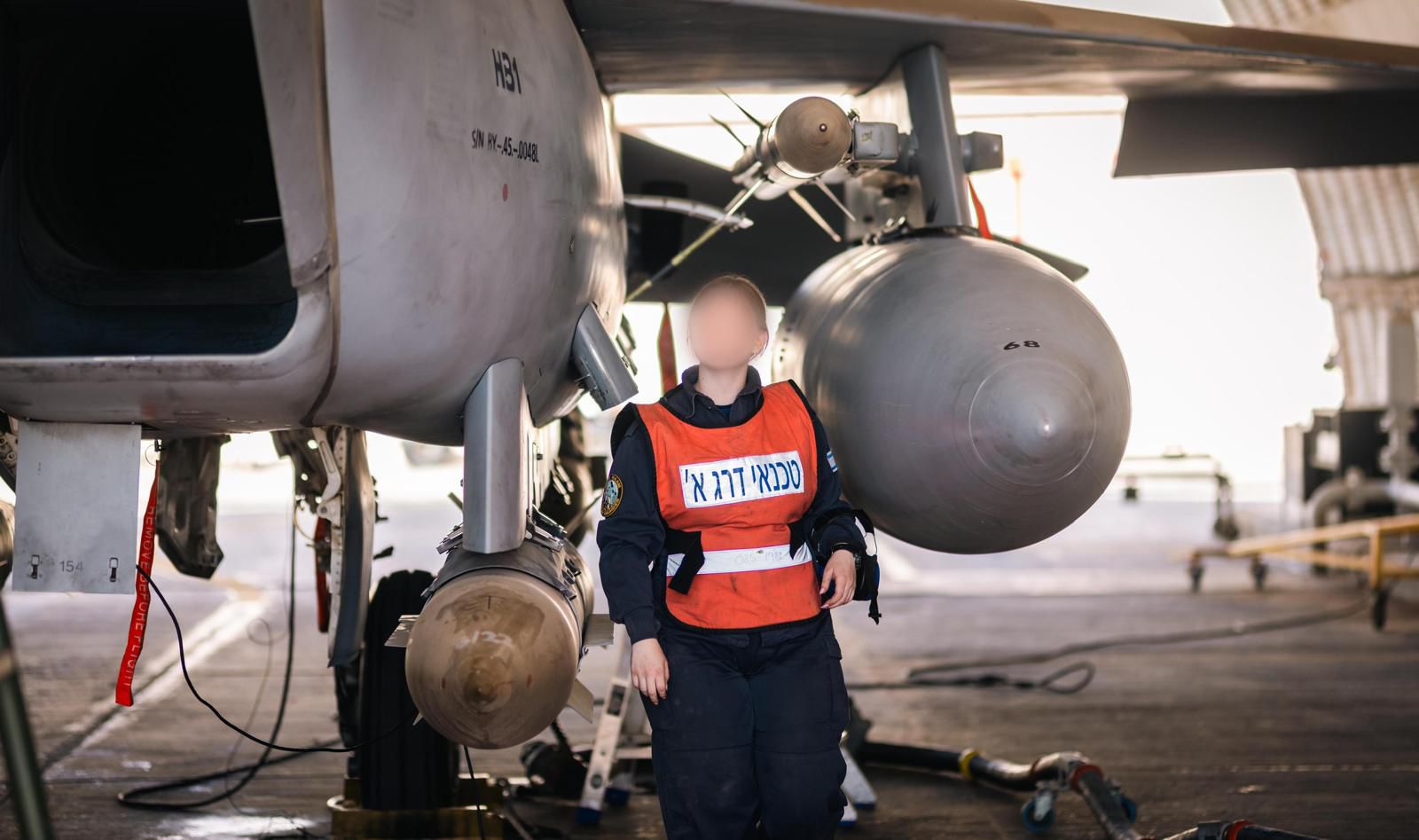 Technician standing near bomb.