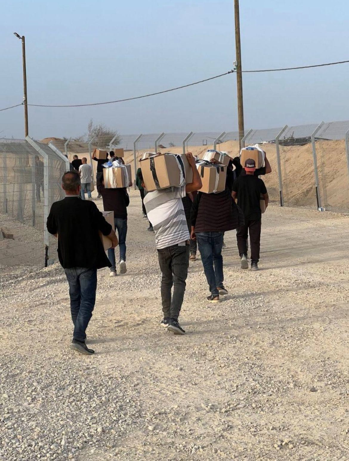 Gazans collect food parcels, 27 May 2025