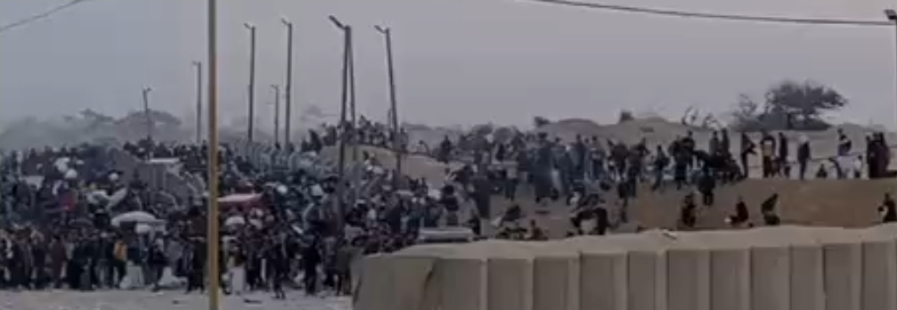 Gazans gathering aid at site peacefully.