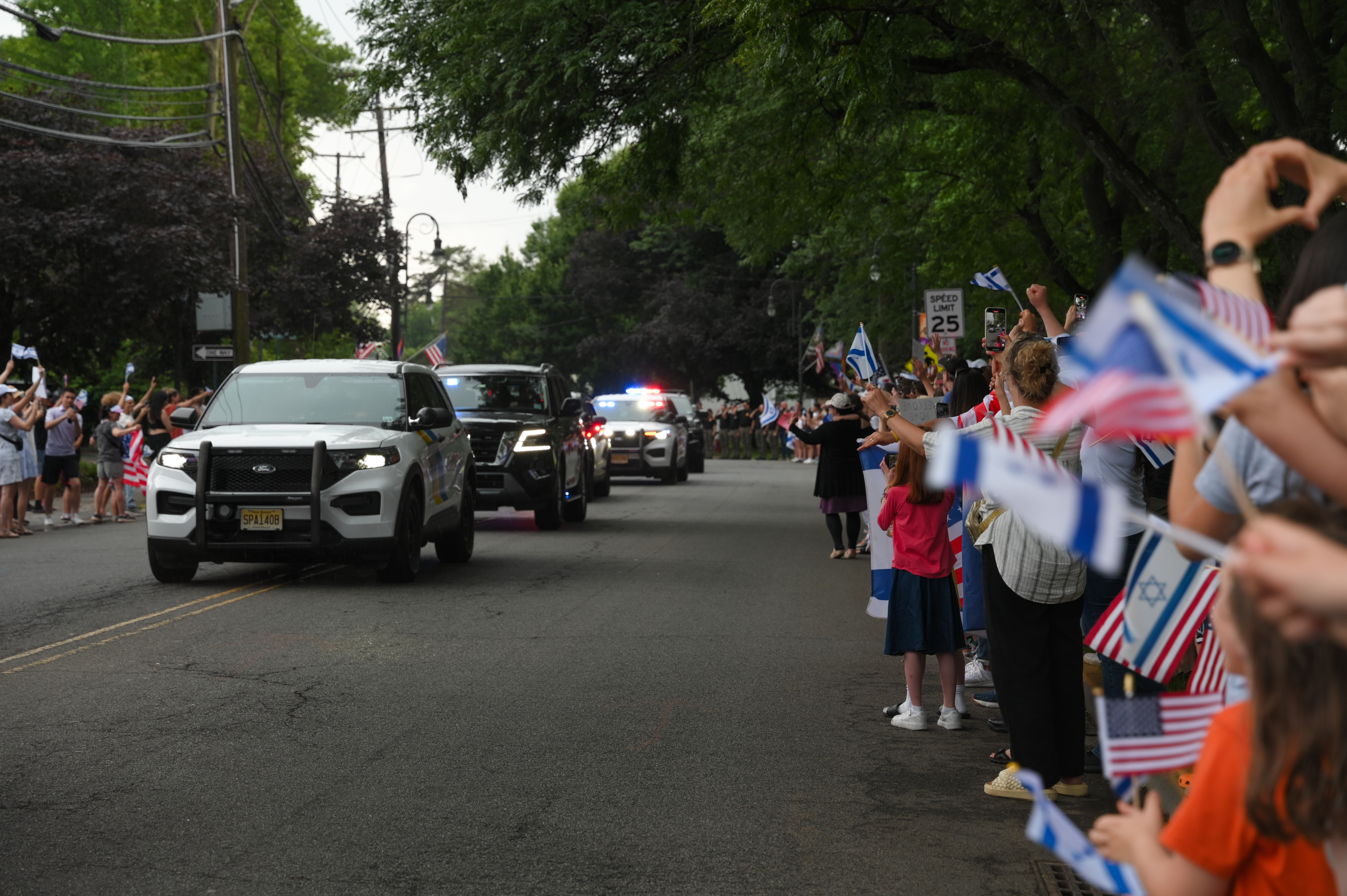People wait for the arrival of Former hostage Edan Alexander near his home in New Jersey, June 19, 2025. 