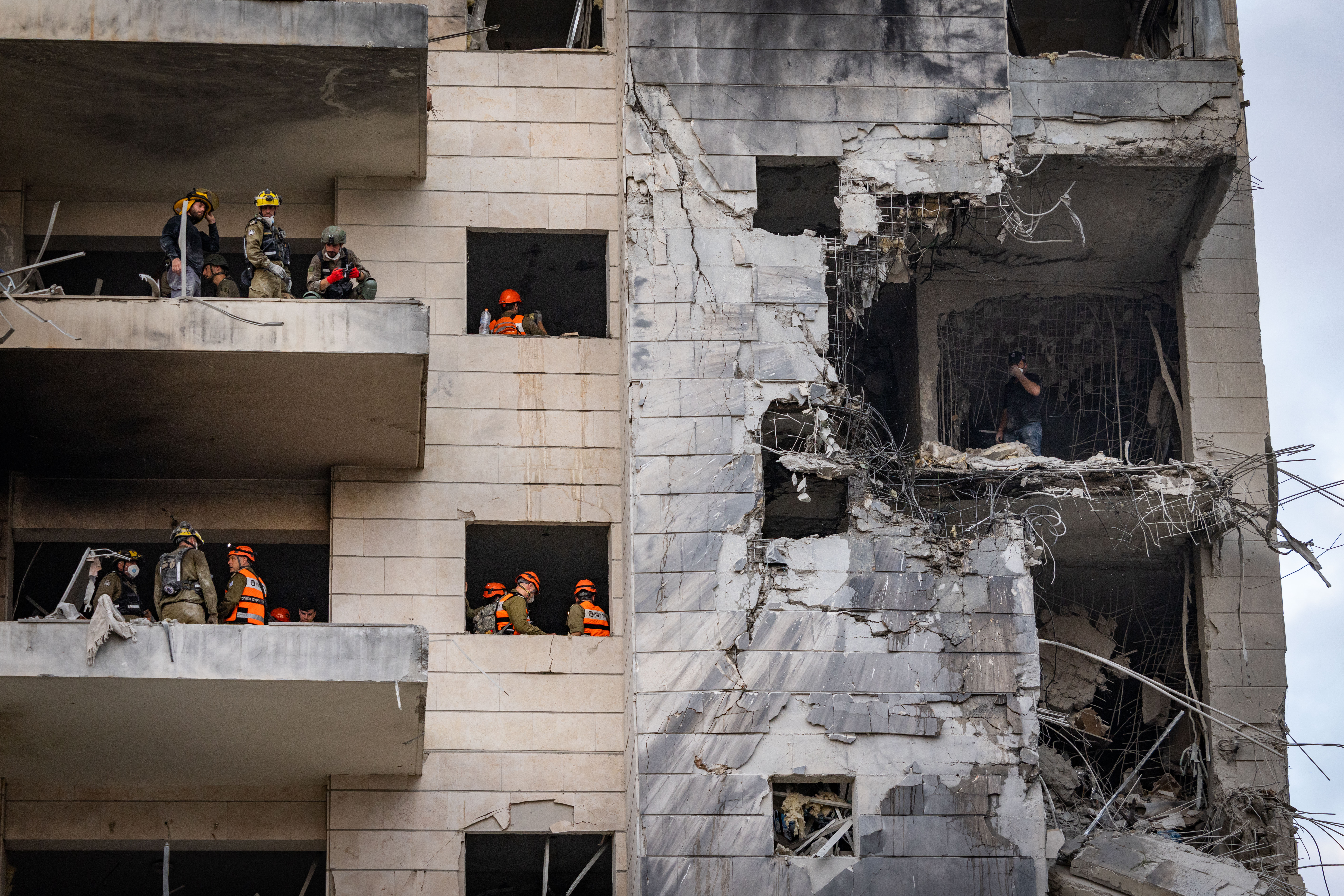 Israeli security and rescue forces at the scene where a ballistic missile fired from Iran hit and caused damage in Petah Tikva, June 16, 2025.