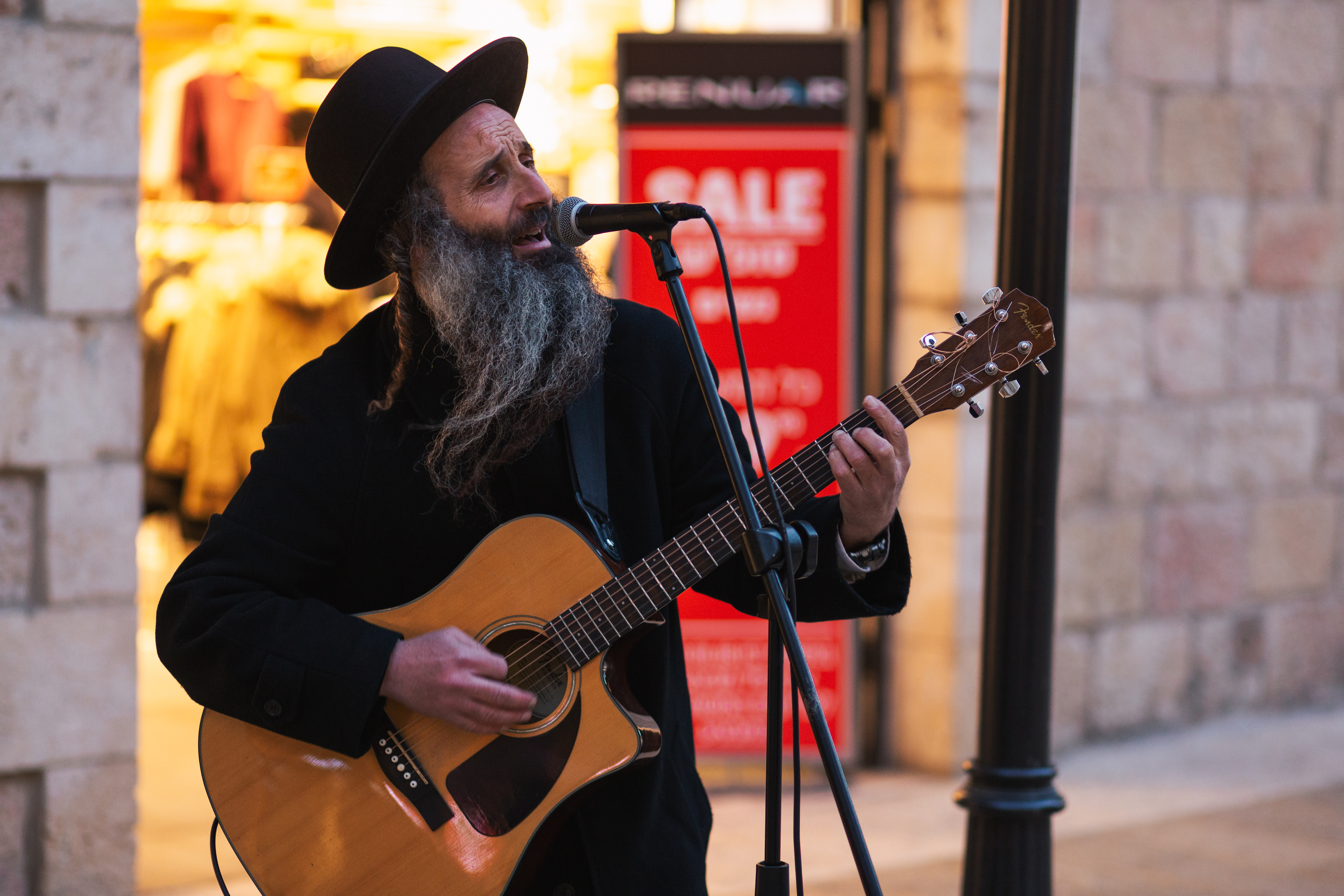An orthodox Jewish man plays guitar