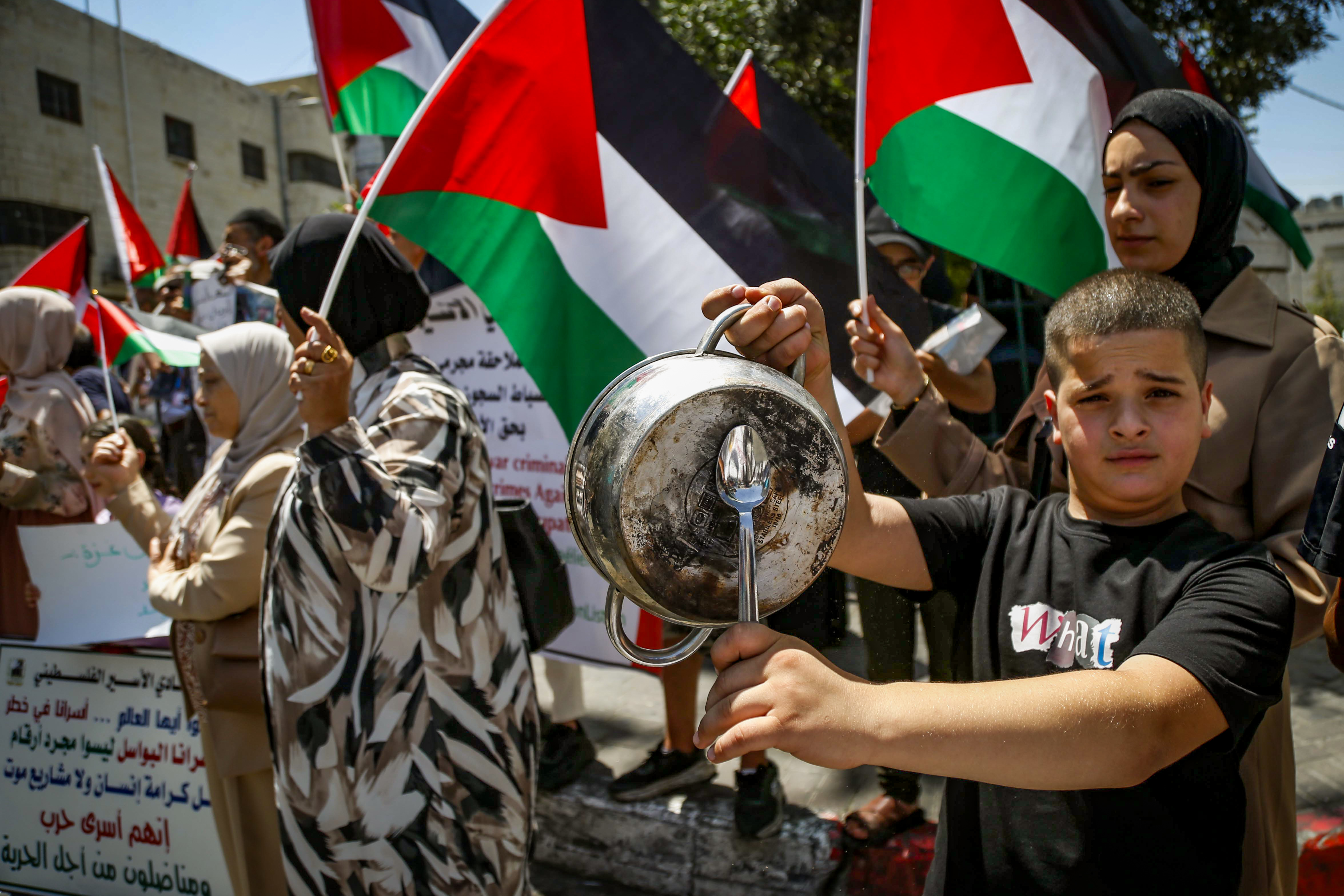 Palestinians attend a protest demanding an end to the war, Hebron, August 3, 2025. 