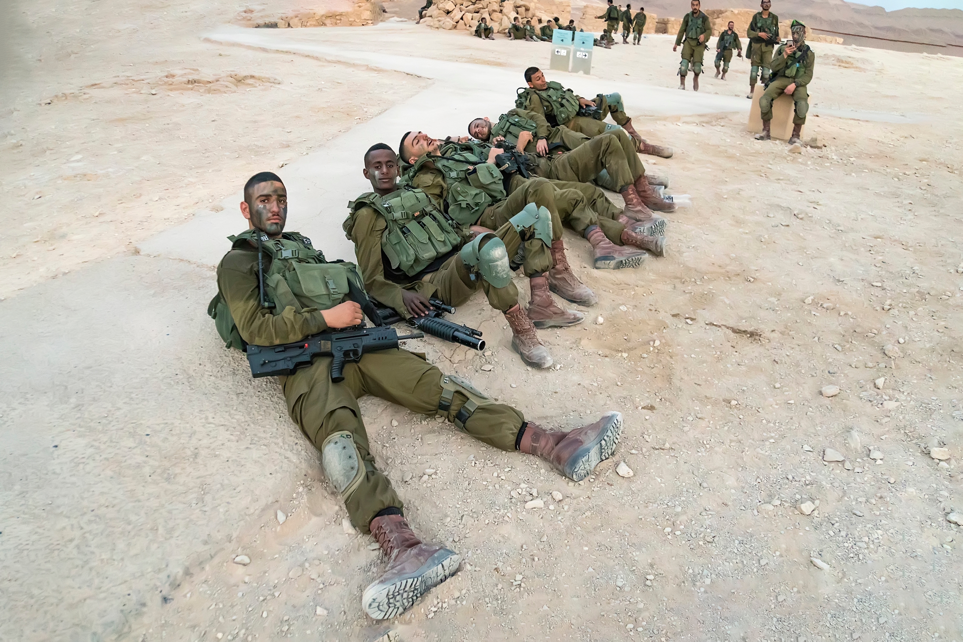 soldiers resting on the ground after military exercises on Masada