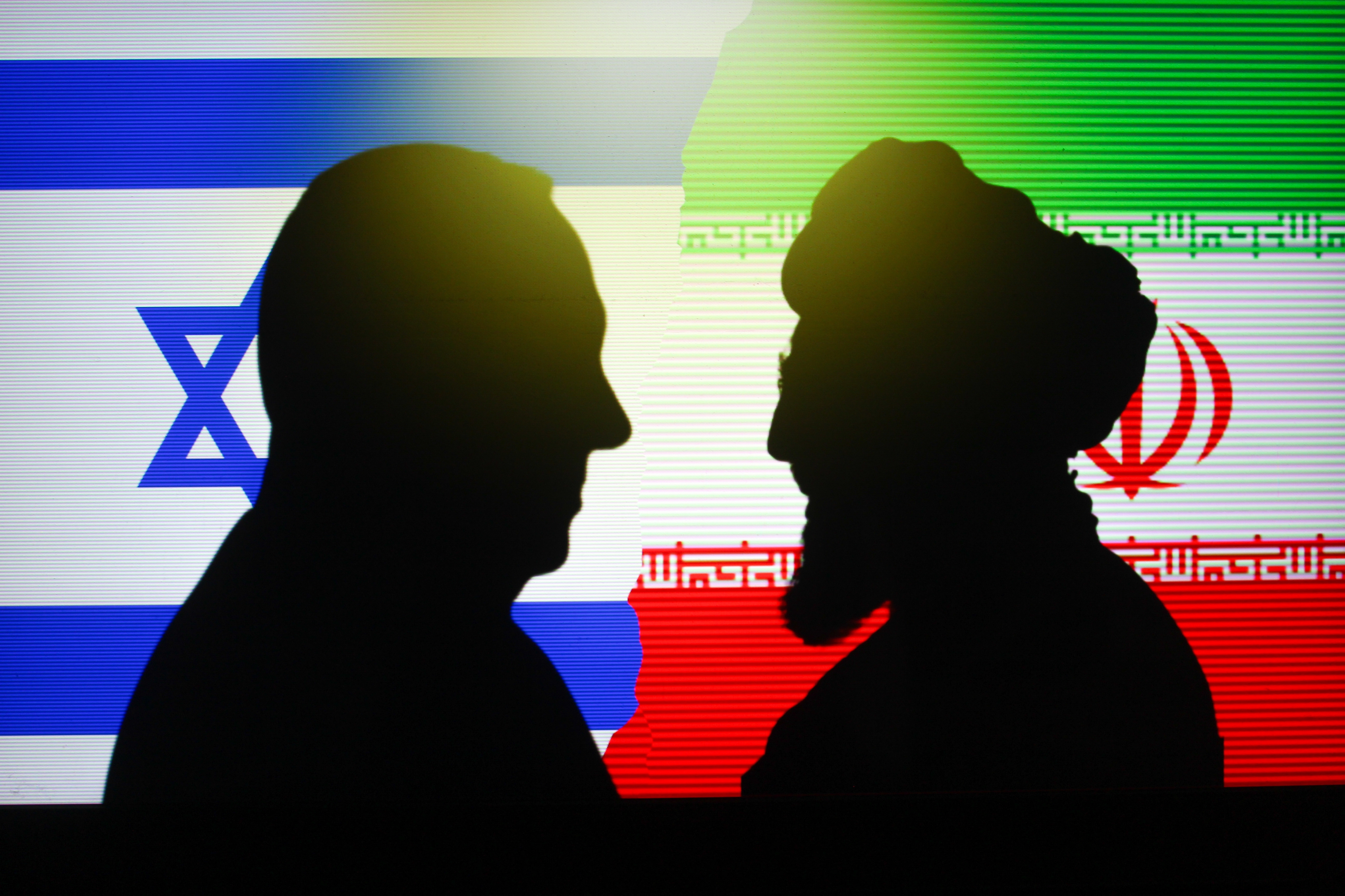 Silhouette of Israel PM Benjamin Netanyahu vs Iran supreme leader Ali Khamenei with national flag background, Concept of war conflict between Iran and Israel. Indonesia - June 12, 2025