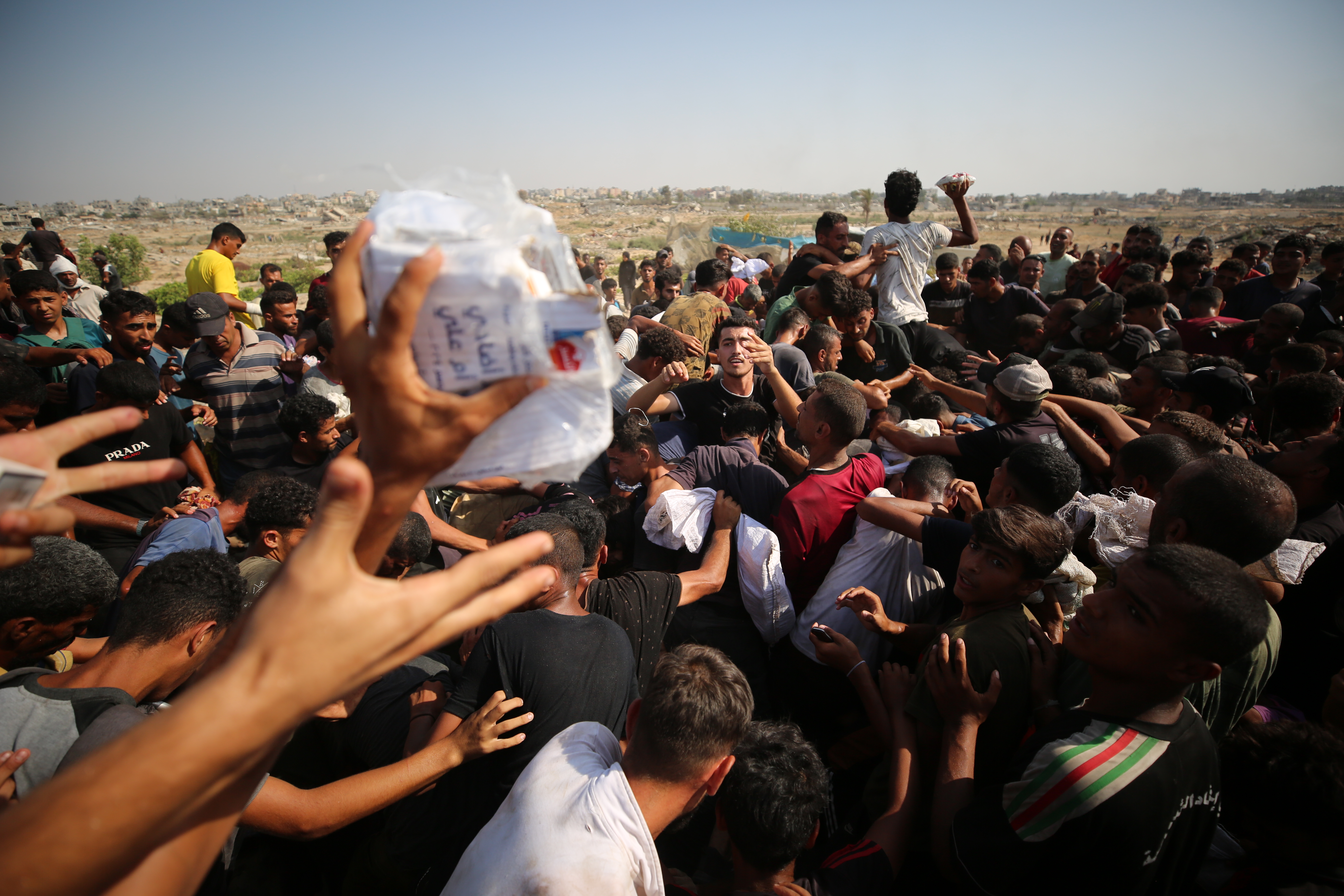 Palestinians at the site where parachuted aid packages landed in Gaza City, August 15, 2025. 