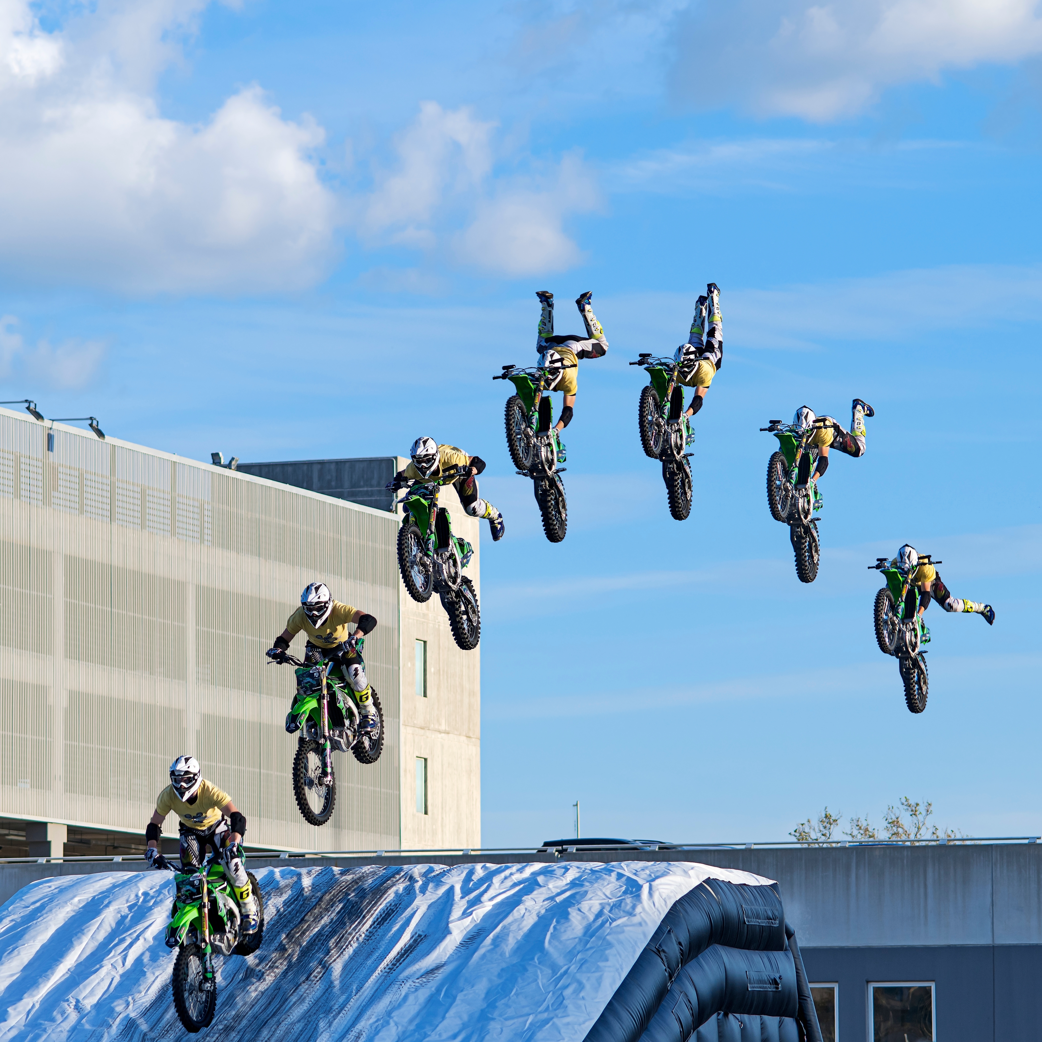  Photomontage motocross rider performing jumps tricks dirt bikes Bikes midair showing off dynamic stunts during the "Expo Levante" fair held in Bari in exhibition center