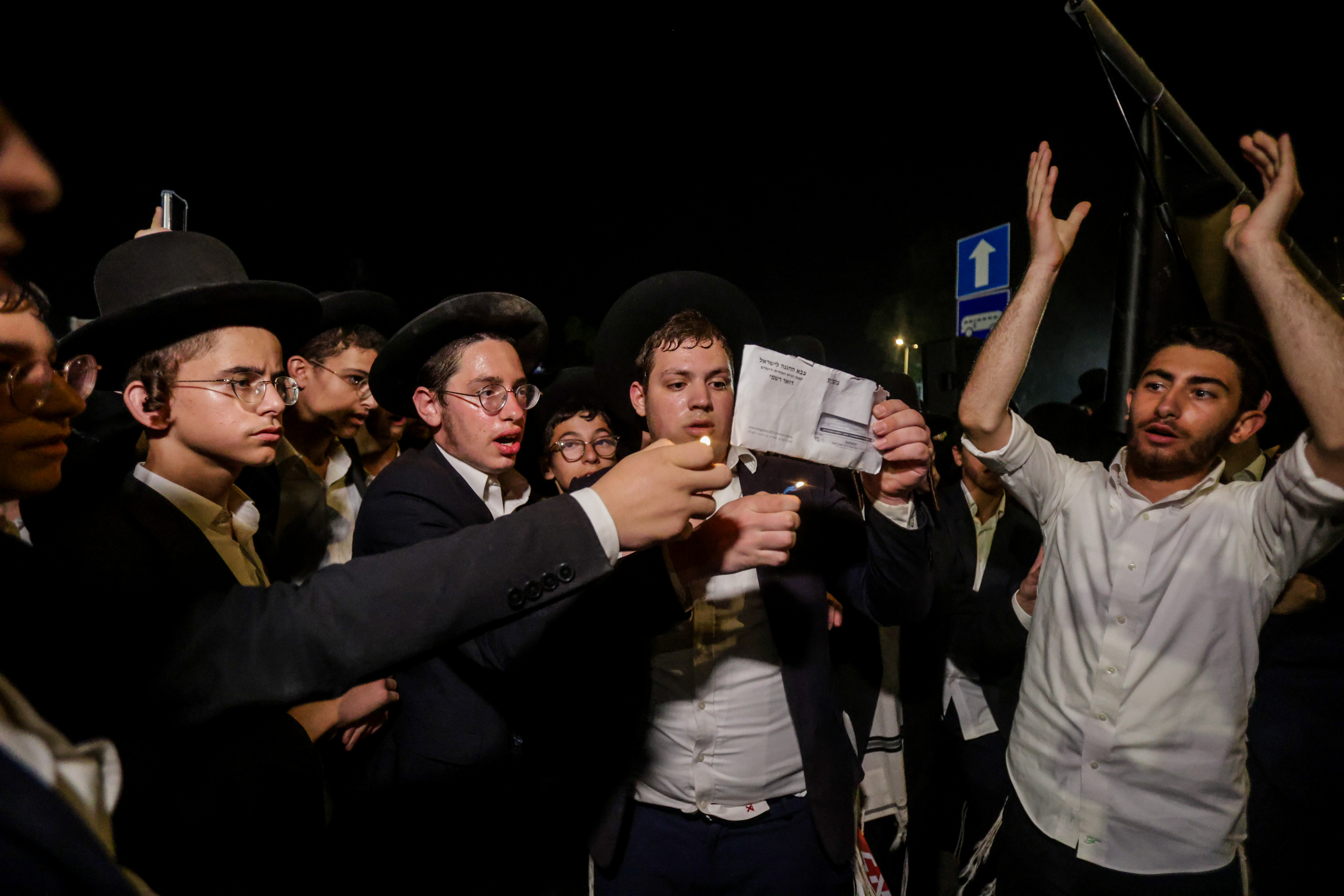 Ultra Orthodox Jewish men attend a rally against the jailing of Jewish seminary students who failed to comply with an army recruitment order outside the military prison in Beit Lid, near Netanya, August 14, 2025.