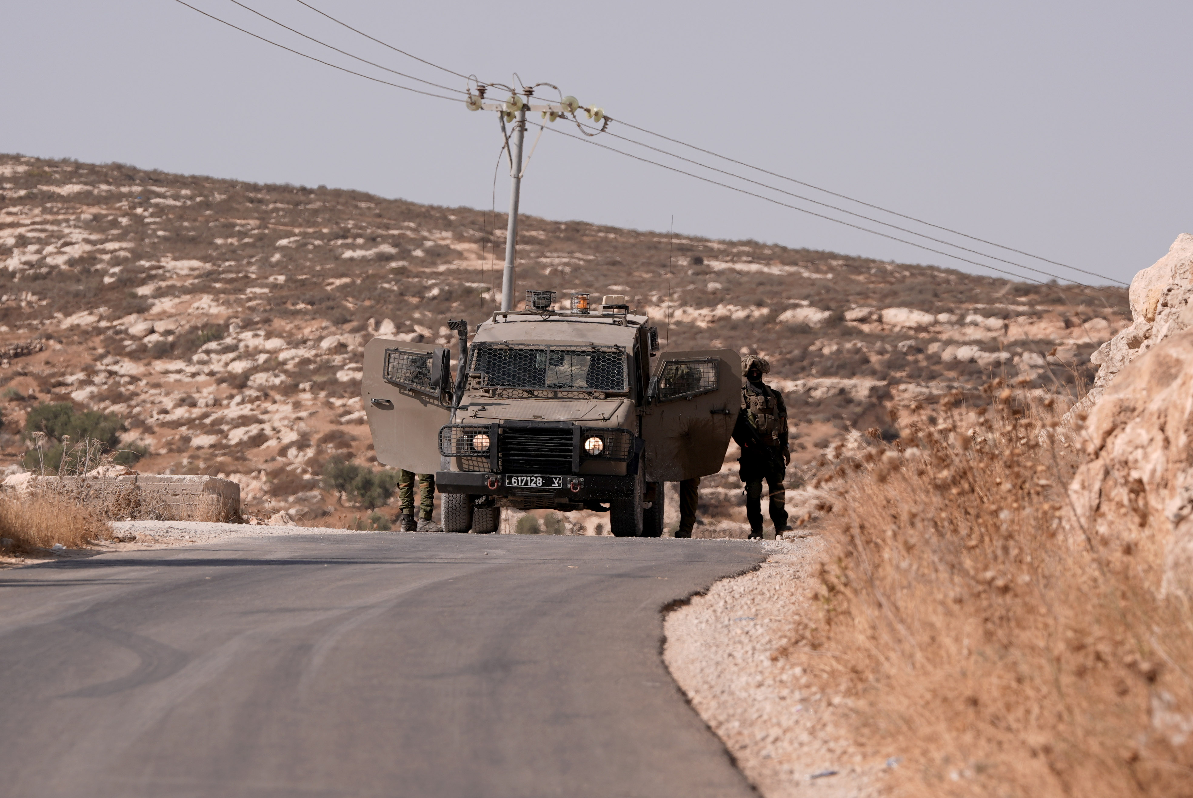 Israeli soldiers guard in  the village of Abu Falah, east of Ramallah, August 16, 2025