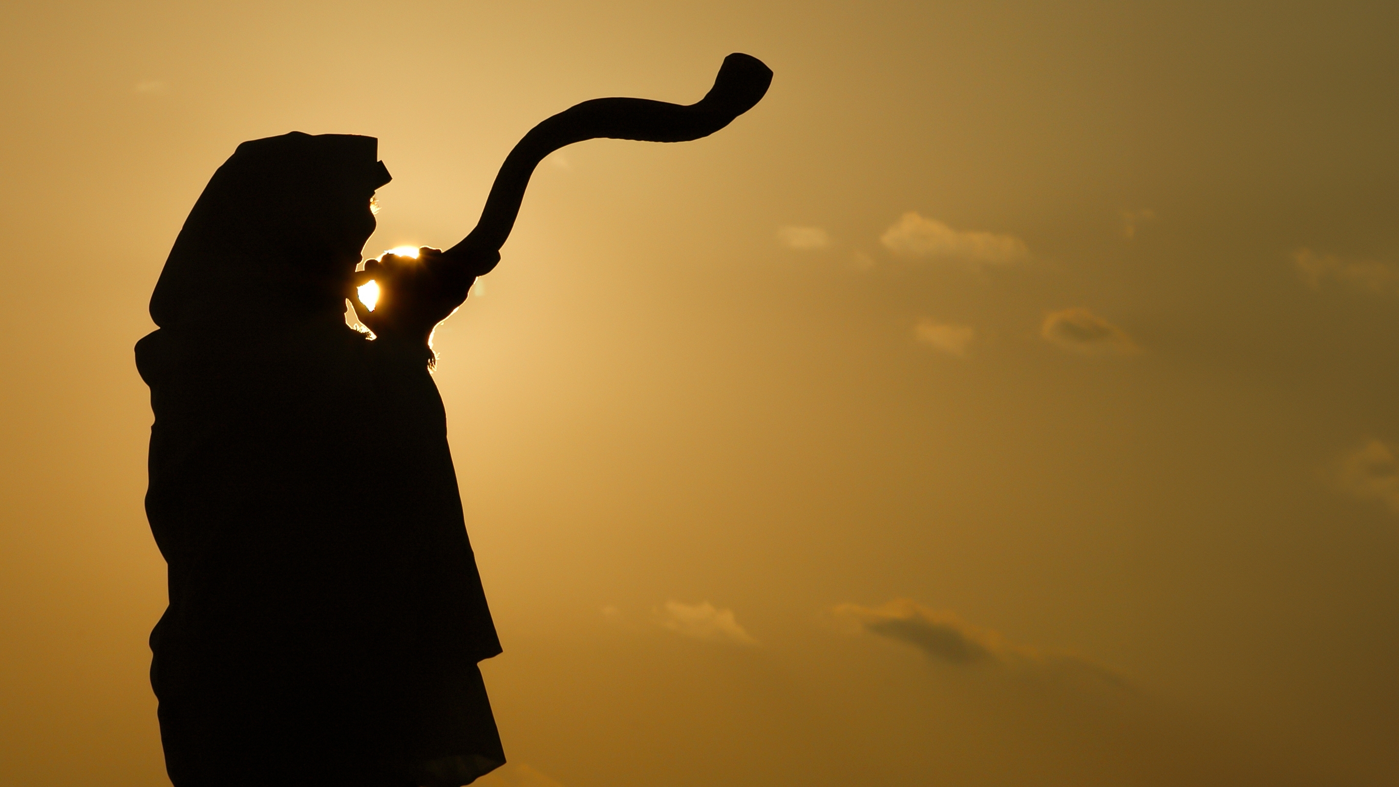 A man playing the shofar