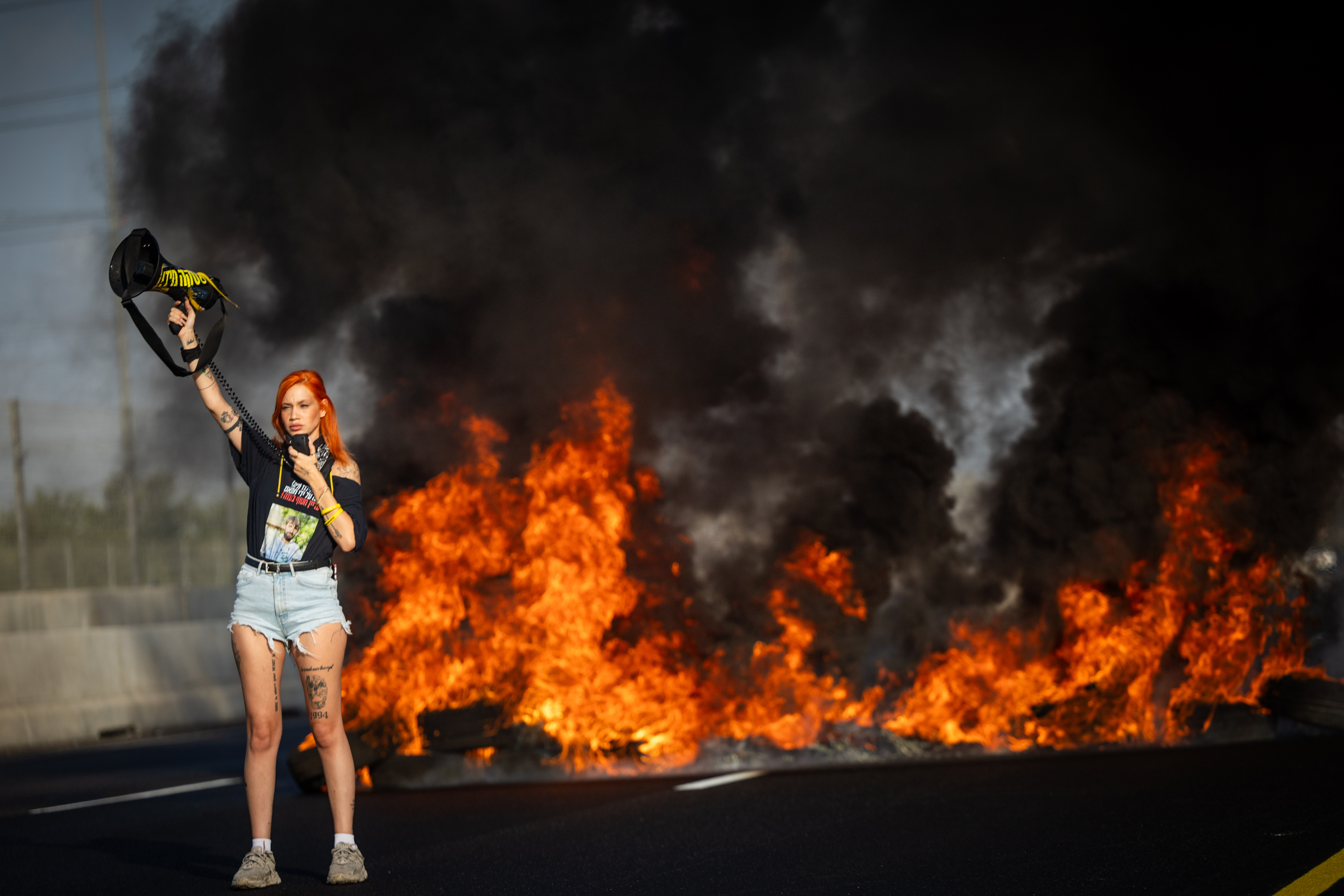 Israelis block a main road near Lod, while attending a protest calling for the release of the Israeli hostages held by Hamas in Gaza, August 26, 2025. 