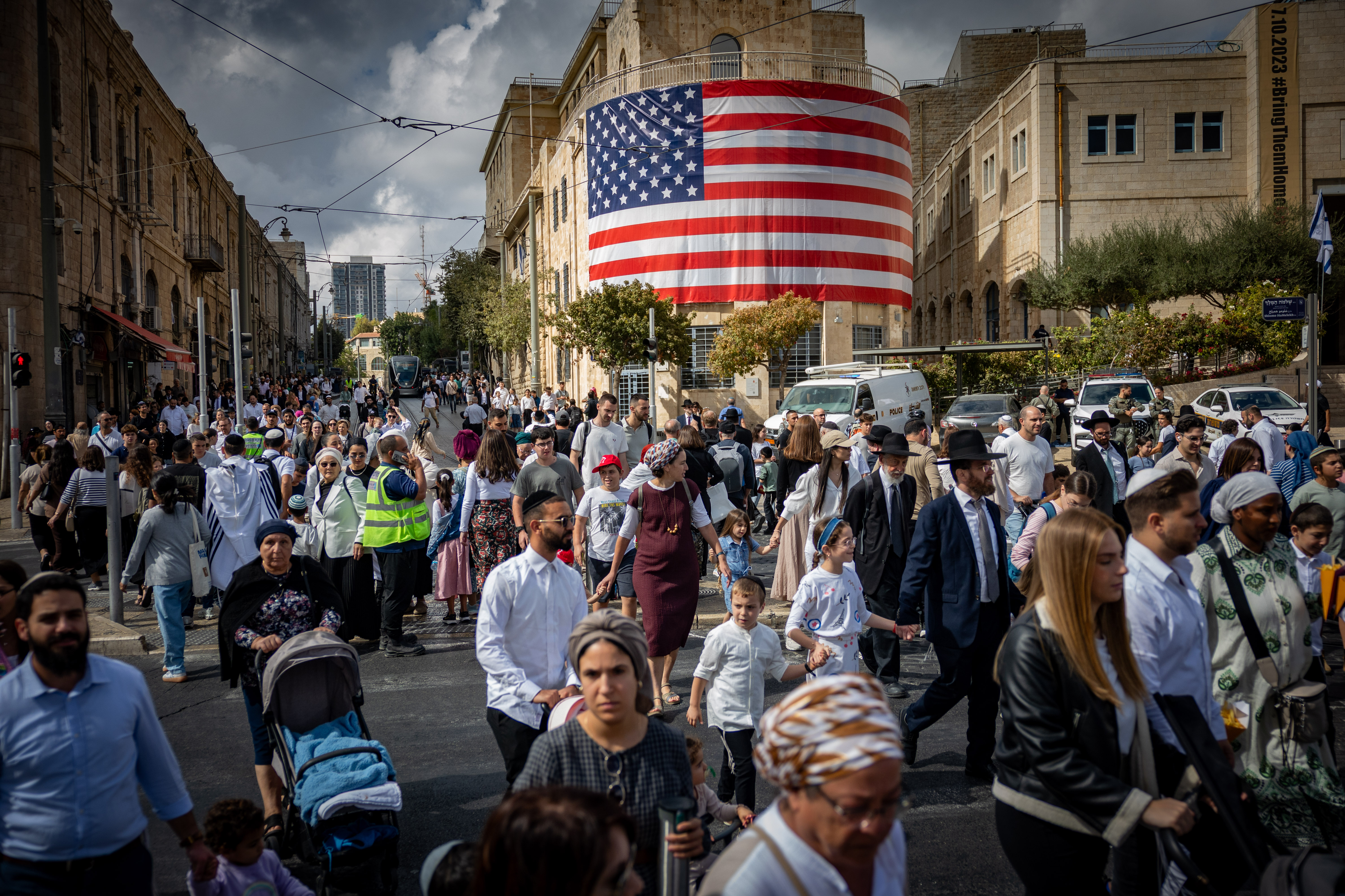 Pepole walking next to a large American flag at the Tsahal Square in Jerusalem, in honor of U.S. President Donald Trump, October 12, 2025. 