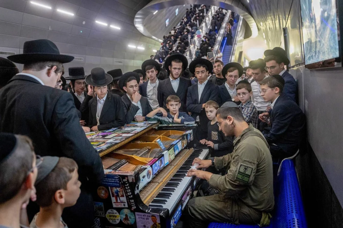 A soldier plays for Haredim en route to the rally