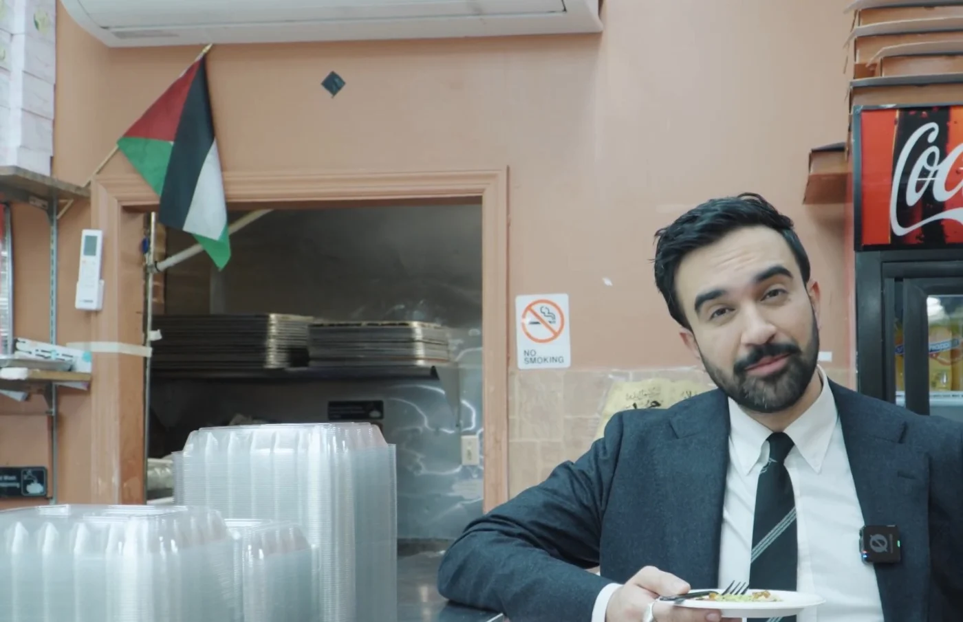 Mayor-Elect Mamdani with a Palestinian flag in the background.