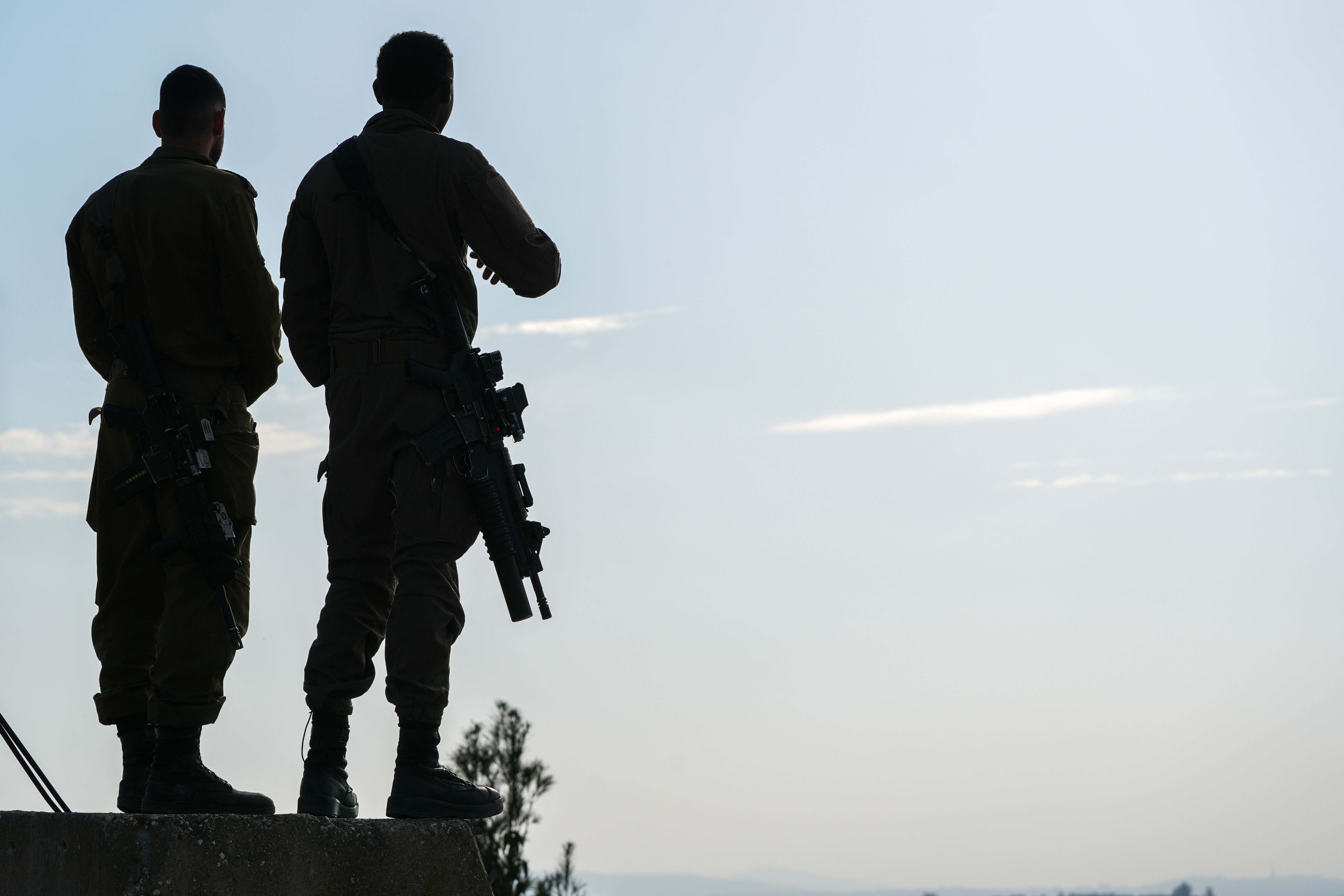Israeli soldiers stand near the border with Lebanon in northern Israel, December 4, 2025.