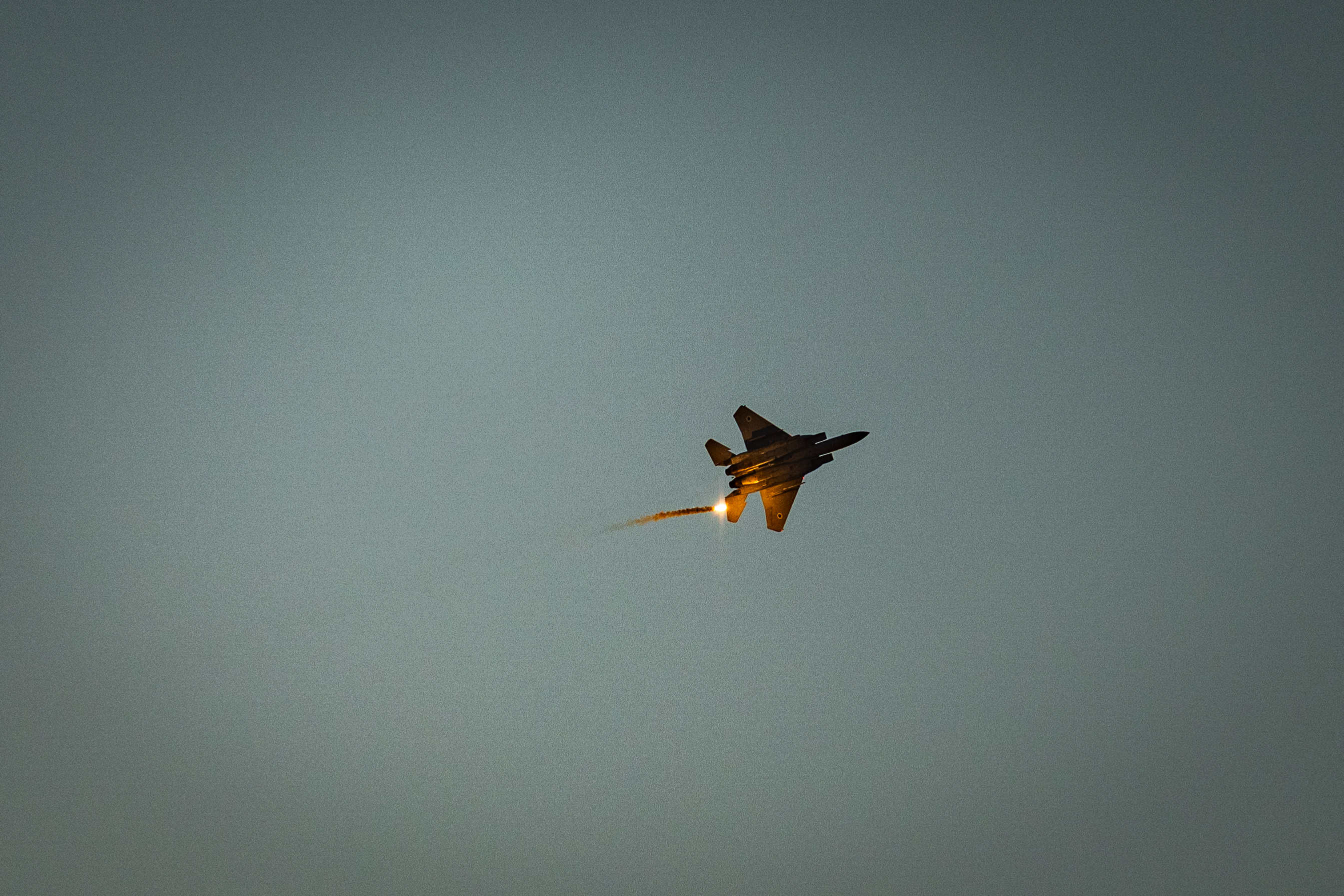 An Israeli Air Force fighter jet firing flares as it flies over the Gaza Strip, as it seen from the Israeli side of the border, July 20, 2025.