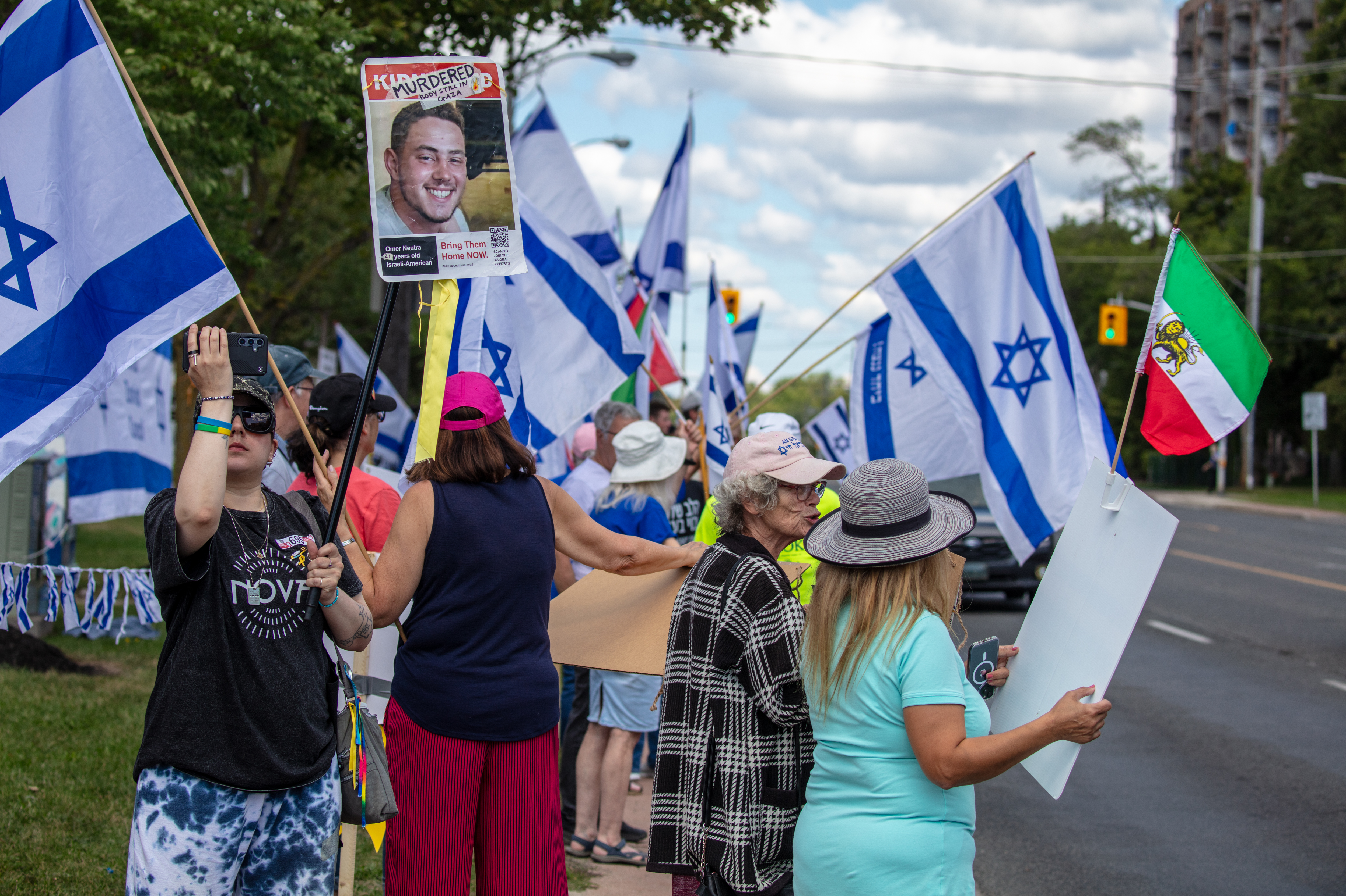 People protest in support of Israel and call for the release of hostages held in Gaza, while across the road pro-Hamas demonstrators rally in their support, in Toronto, Canada, August 31, 2025. 