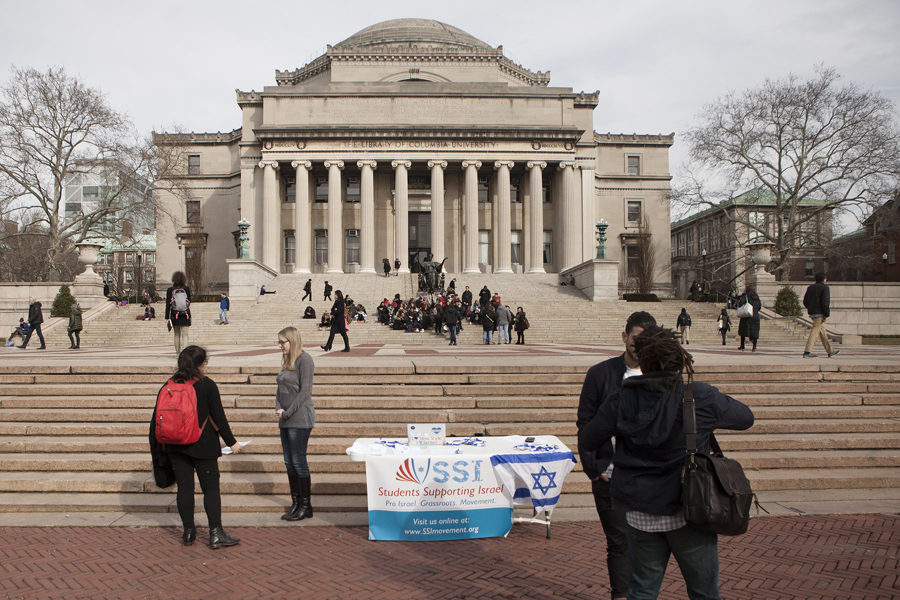 An American student hands out flyers for 'SSI' the Students Supporting Israel Movement, outside Columbia University library in New York City, on February 4, 2016. 