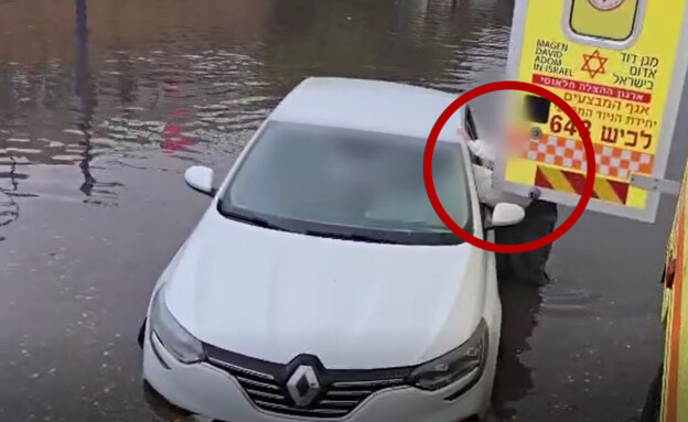 People being rescued from their cars after severe flooding in Yavne