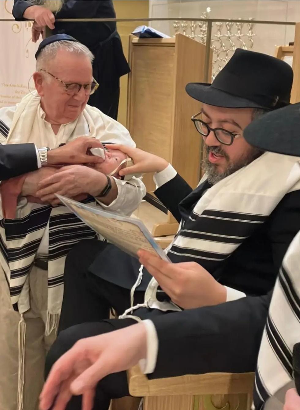 Rabbi Schlanger officiating at a brit mila. 