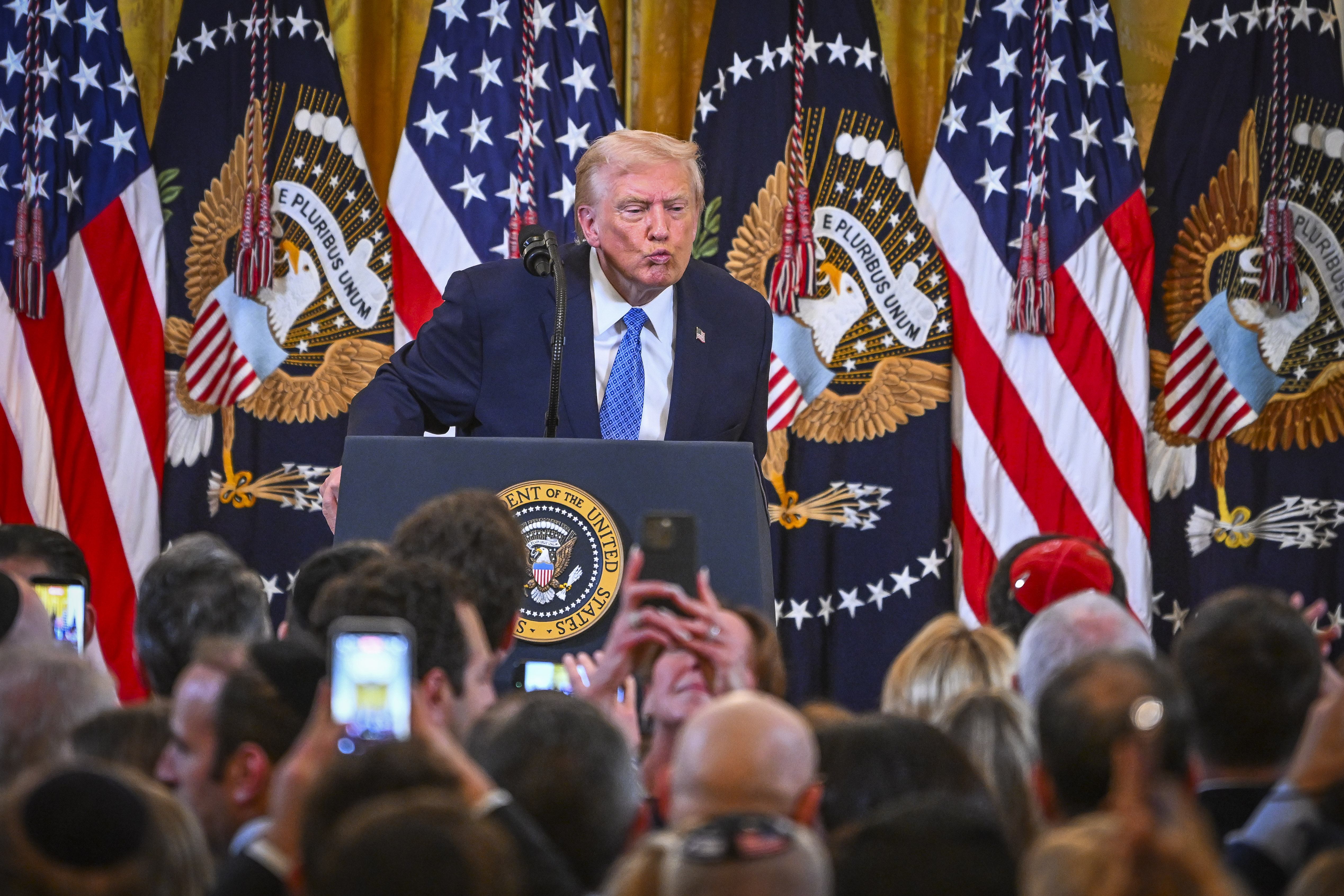 U.S. President Donald Trump attends a Hanukkah reception in the East Room of the White House in Washington, D.C., on December 16, 2025. 