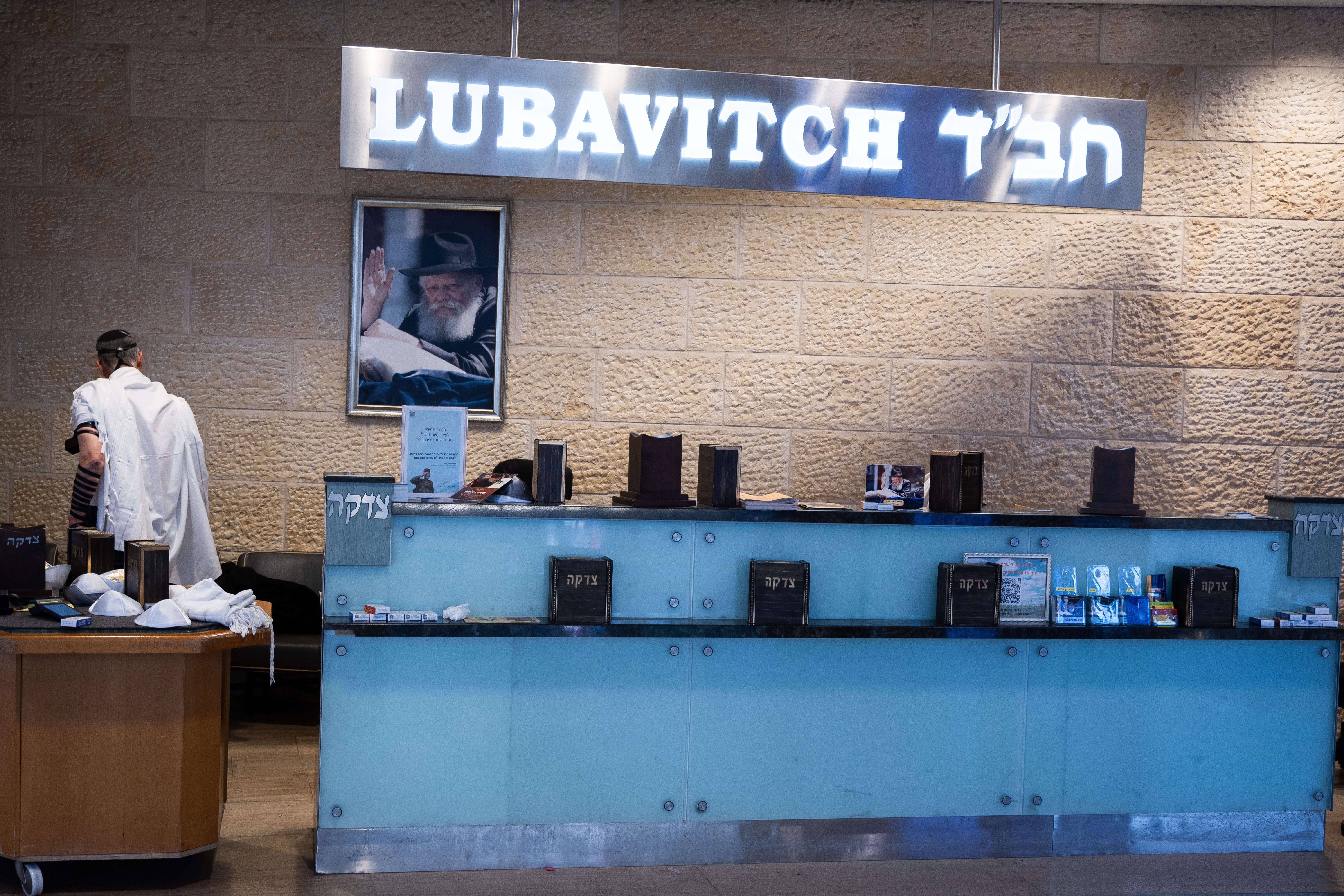 An orthodox Jewish man prays at a Chabad counter in the Ben Gurion International airport near Tel Aviv on January 26, 2024.