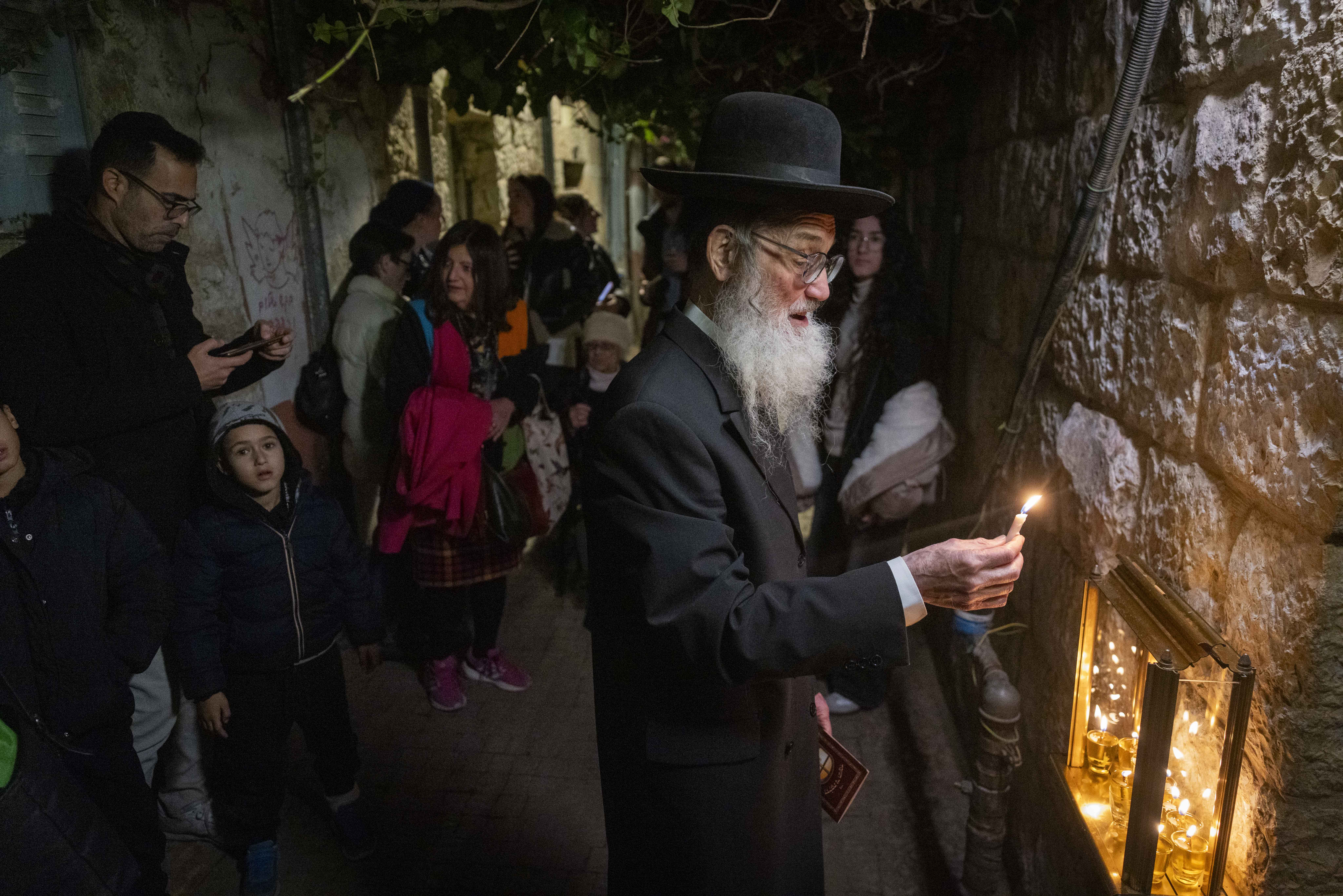 Haredi man light Hanukkah candles, Nachalot, December 2025