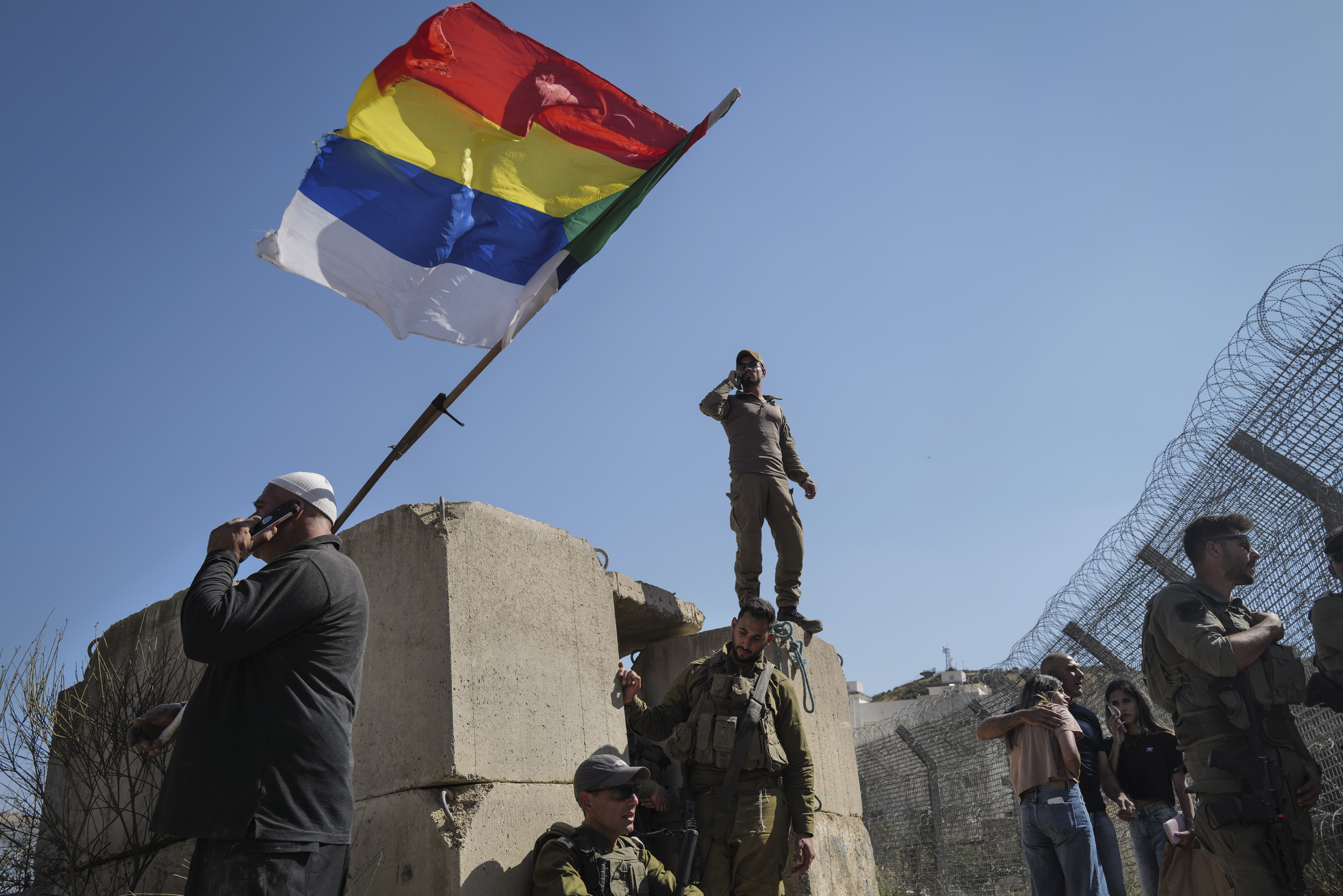Druze residents protest near the Israeli-Syrian border fence in solidarity with their community in Syria, July 16, 2025.