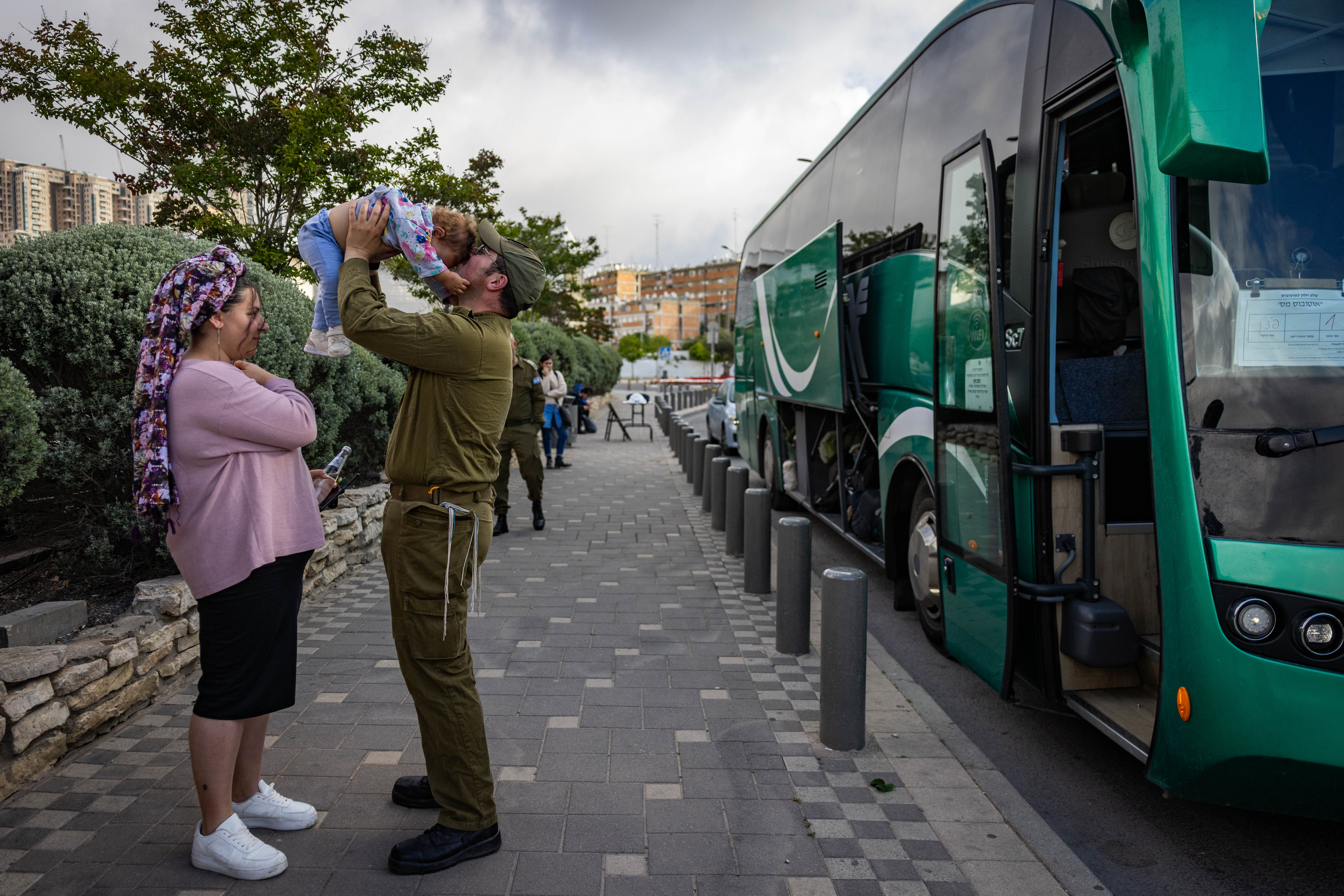 An Israeli reserve soldier kissing goodbye his child as he leaves for his deputy service, in Jerusalem, May 5, 2025.